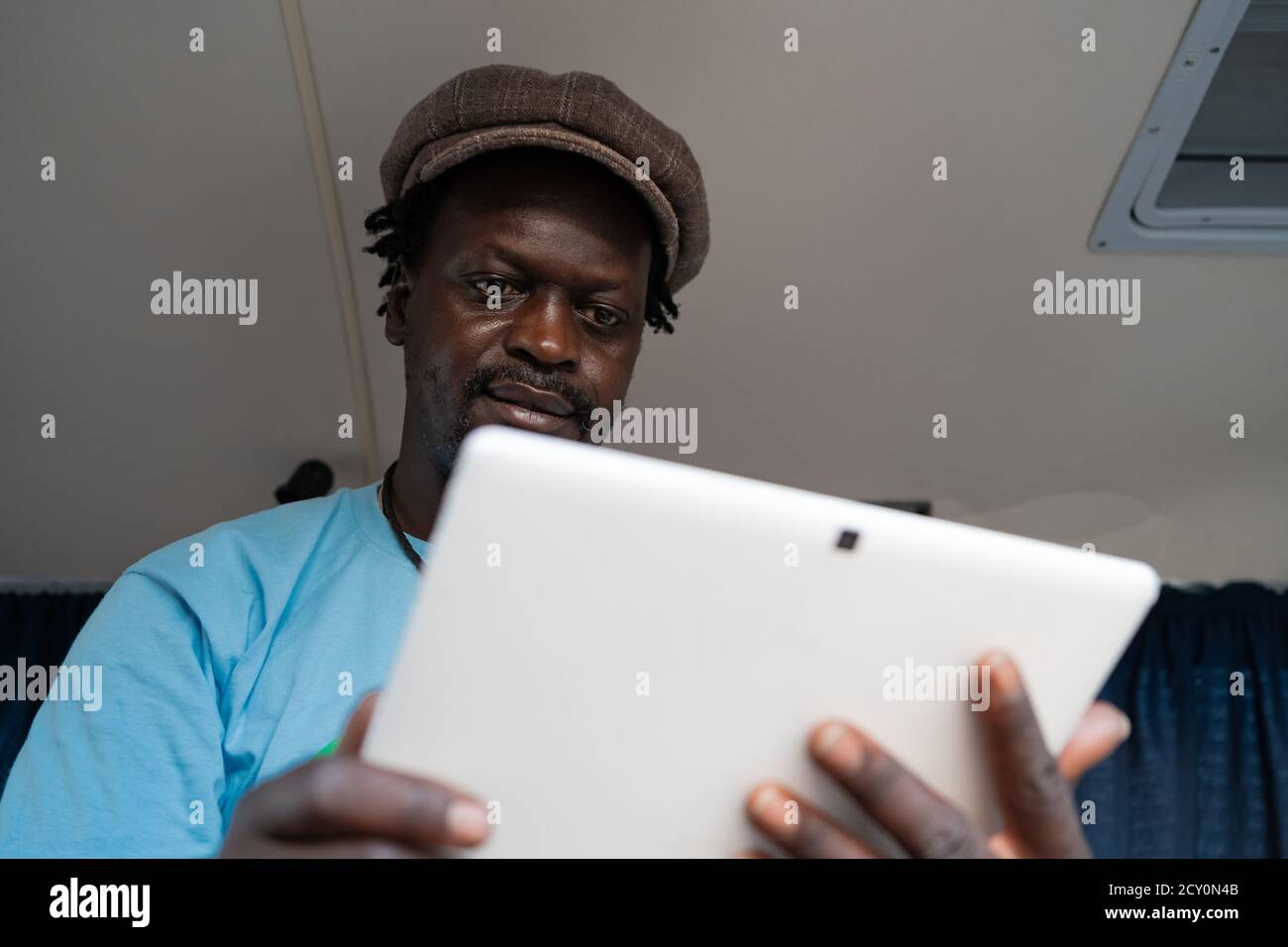 African black boy working with tablet inside a van Stock Photo