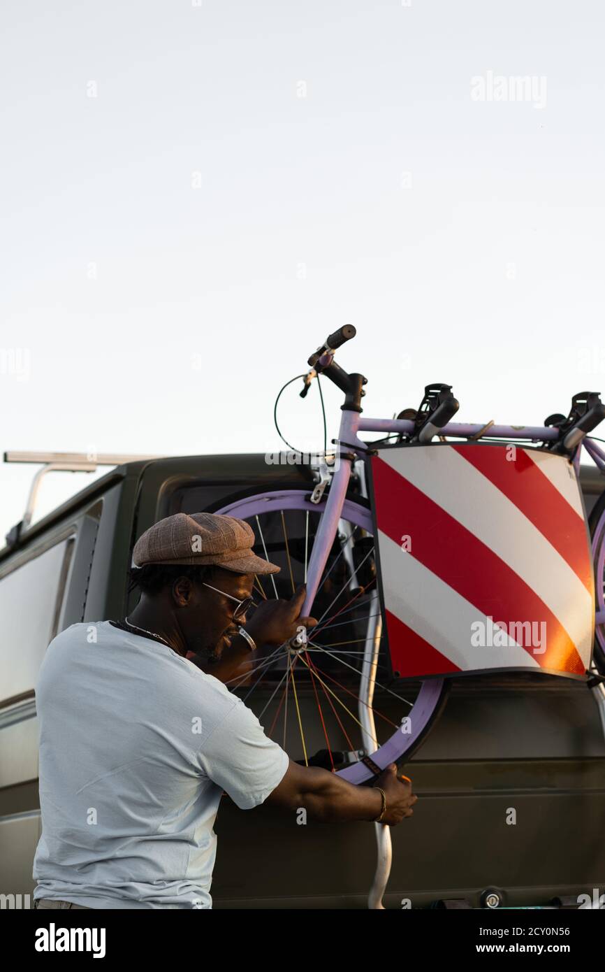 African American black man with a bicycles in his camper van Stock Photo