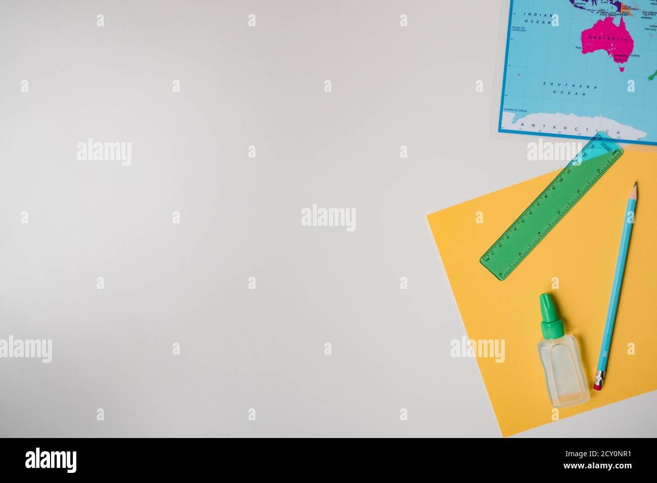 education materials with map, paper, pencil on white background Stock Photo
