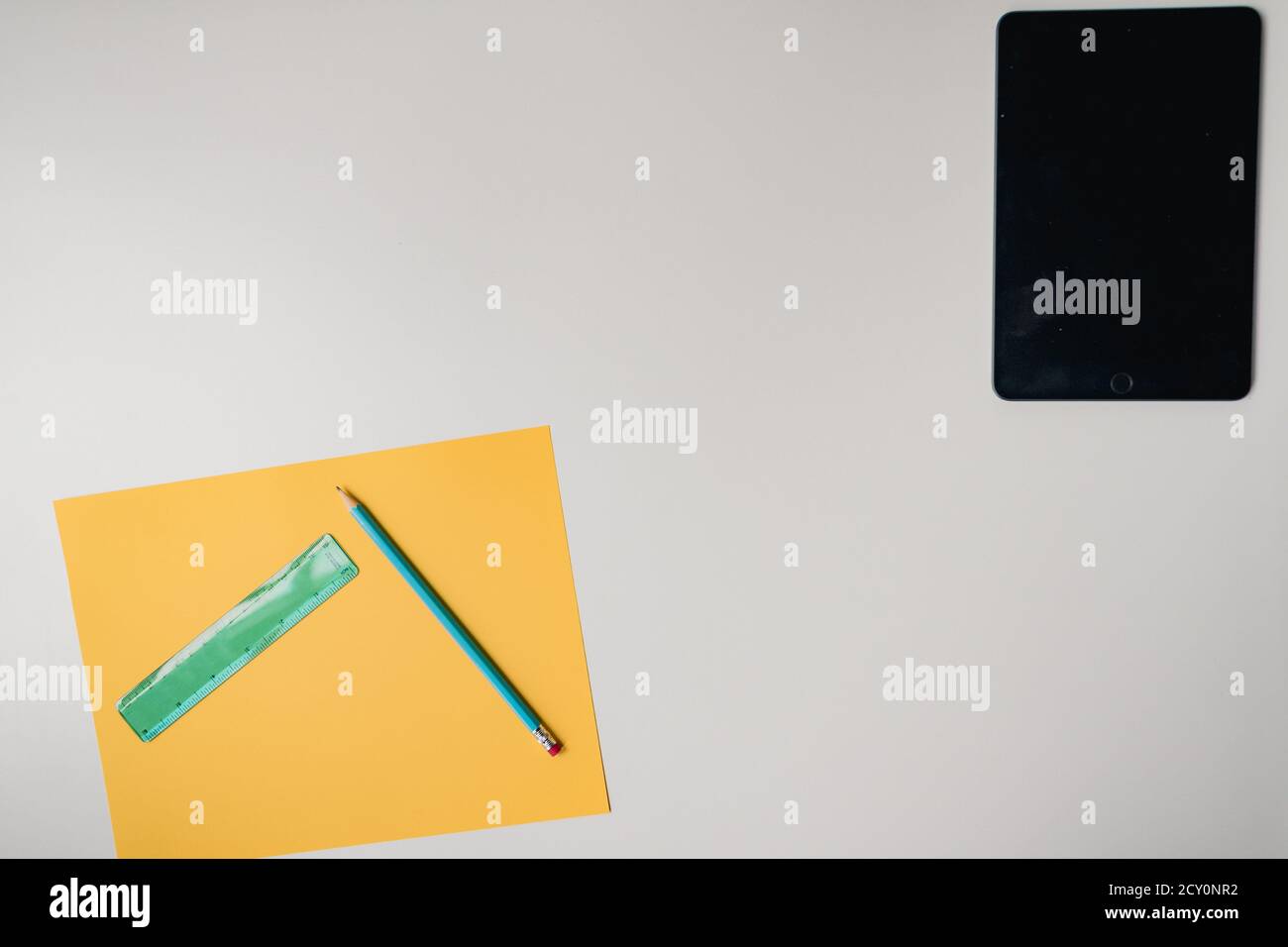 tablet and craft supplies on plain white background Stock Photo