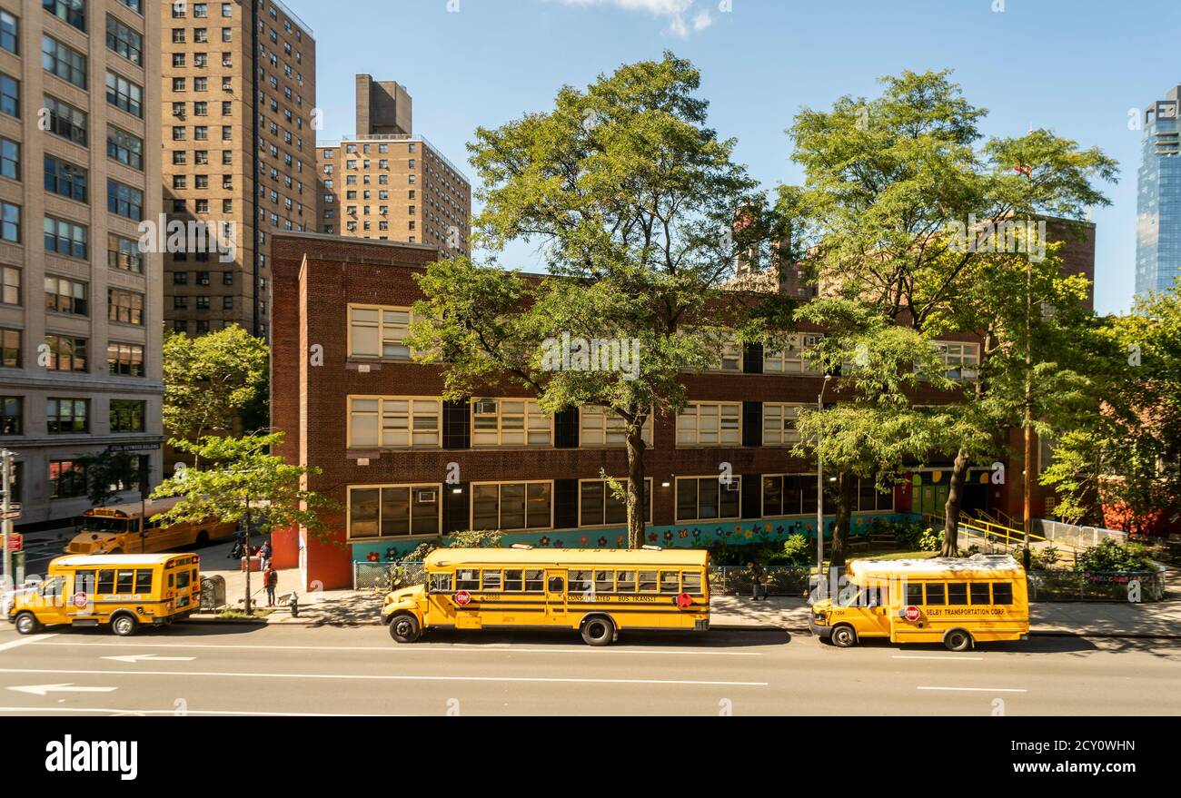 School buses line outside PS33 in Chelsea in New York on Wednesday, September 30, 2020 waiting for dismissal. Pre-K, pre-K3, and students with disabilities. K-5 schools and K-8 schools began on Sept. 29, and middle schools, high schools, and adult education going back on Oct. 1. (© Richard B. Levine) Stock Photo
