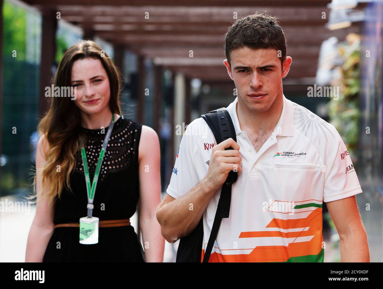 Force India Formula One driver Paul di Resta of Britain (R) arrives with  his girlfriend Laura Jordan before the third practice session of the  Singapore F1 Grand Prix at the Marina Bay