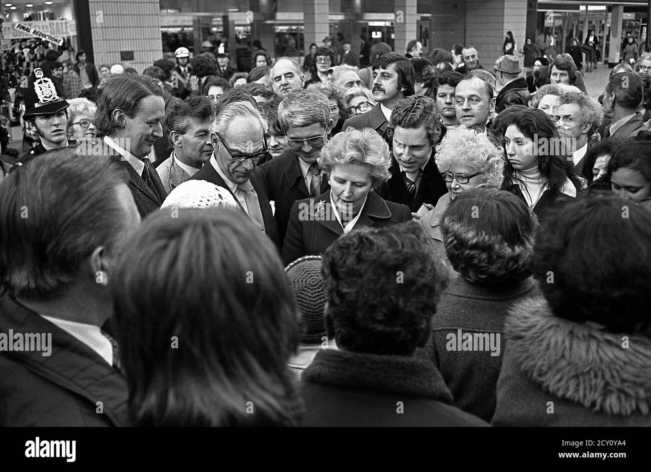 AJAXNETPHOTO.11TH FEBRUARY,1977. PORTSMOUTH, ENGLAND.  - CITY WALKABOUT - MRS MARGARET THATCHER (CON), LEADER OF THE OPPOSITION, ENGAGES WITH THE PUBLIC IN COMMERCIAL ROAD SHOPPING PRECINCT DURING A CAMPAIGN WALKABOUT. HER HUSBAND DENIS STANDS ON MRS THATCHER'S RIGHT.PHOTO:JONATHAN EASTLAND/AJAX REF:3771102 45 Stock Photo