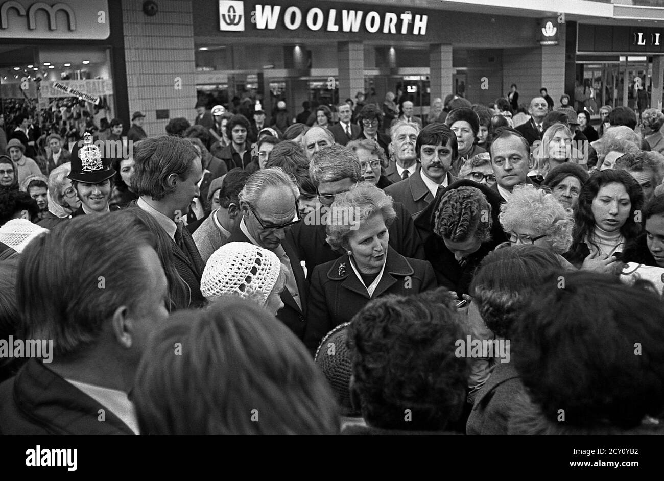 AJAXNETPHOTO.11TH FEBRUARY,1977. PORTSMOUTH, ENGLAND.  - CITY WALKABOUT - MRS MARGARET THATCHER (CON), LEADER OF THE OPPOSITION, ENGAGES WITH THE PUBLIC IN COMMERCIAL ROAD SHOPPING PRECINCT DURING A CAMPAIGN WALKABOUT. HER HUSBAND DENIS STANDS ON MRS THATCHER'S RIGHT. PHOTO:JONATHAN EASTLAND/AJAX REF:3771102 46 Stock Photo