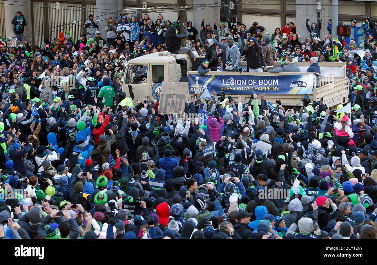 Seattle Seahawks' Richard Sherman (on truck, standing, blue beanie)  celebrates with fans during the NFL team's Super Bowl victory parade in  Seattle, Washington February 5, 2014. REUTERS/Ben Nelms (UNITED STATES -  Tags: