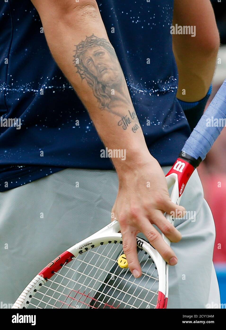 A tattoo is seen on the arm of Britain's Daniel Evans during his men's  singles match against Austria's Jurgen Melzer at the Queen's Club  Championships tennis tournament in west London June 9,
