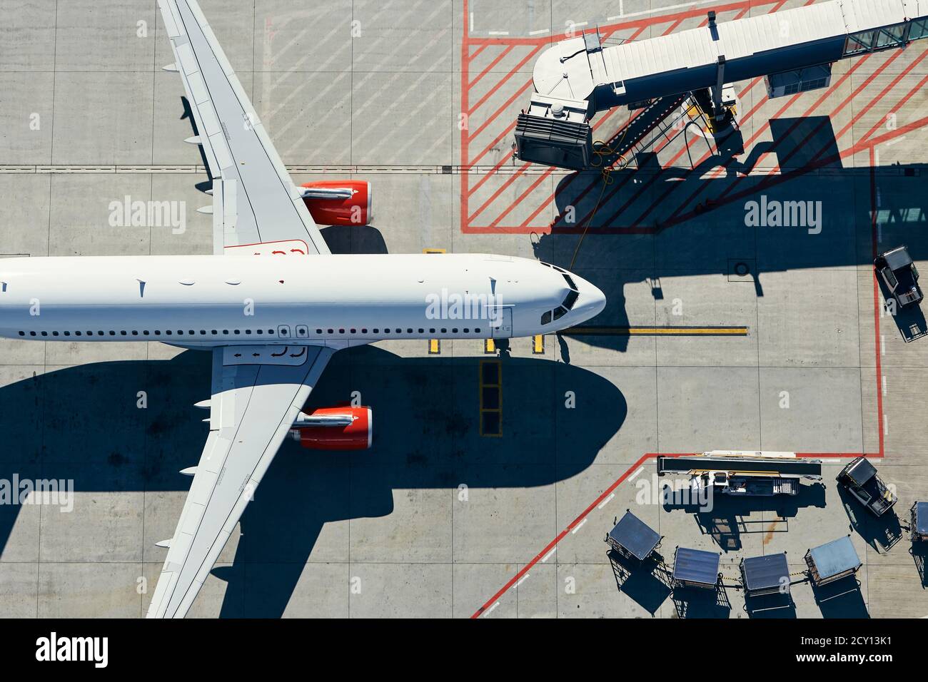Aerial view of airport. Airplane is taxiing to gate of terminal. Stock Photo