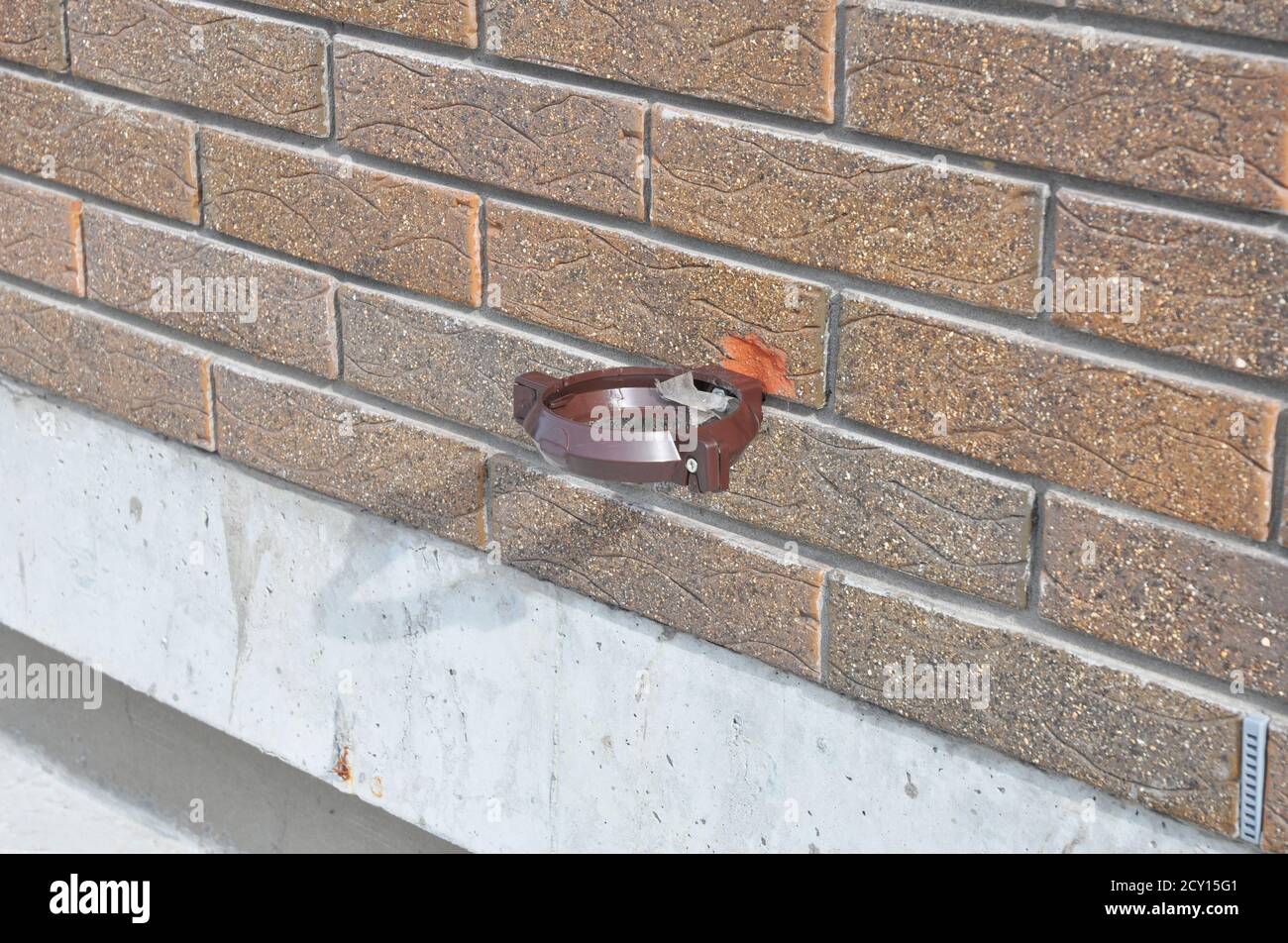 Plastic rain gutter holder for rain gutter downspout pipe. Installing