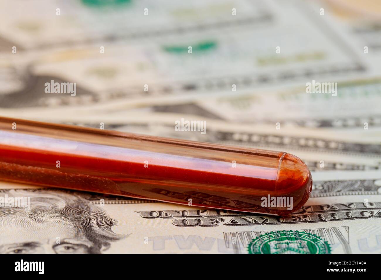The concept of medical expenses blood test with of hundred-dollar bills. Stock Photo