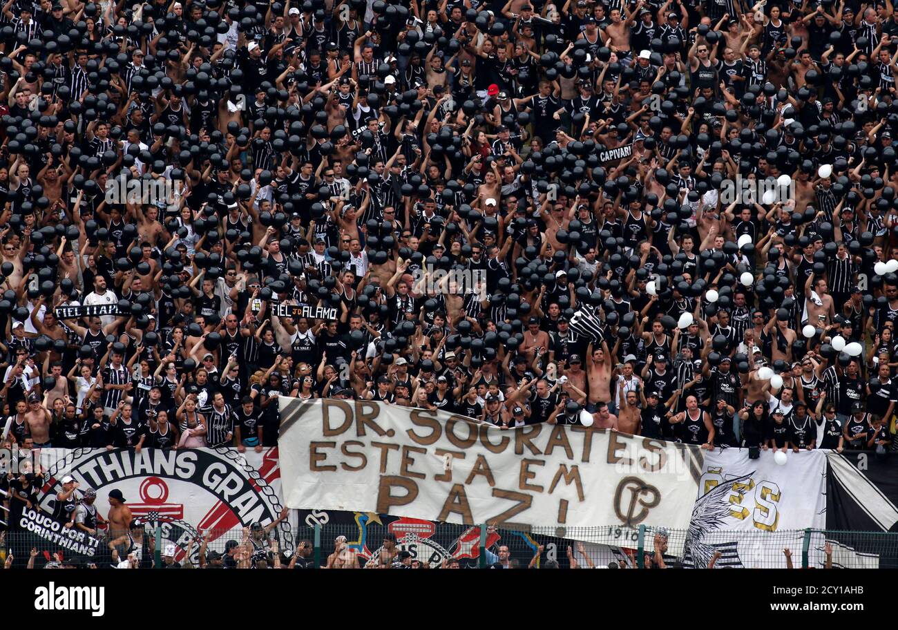 Fans of Corinthians hold a banner that read " Socrates, rests in Peace " before their Brazilian championship soccer match against Palmeiras in Sao Paulo December 4, 2011. Brazil 1982 World Cup captain Socrates, the 'Golden Heel' renowned as one of the great playmakers of his generation, died in hospital on Sunday of septic shock at the age of 57, his doctors said in a statement. REUTERS/Nacho Doce (BRAZIL - Tags: SPORT SOCCER OBITUARY) Stock Photo
