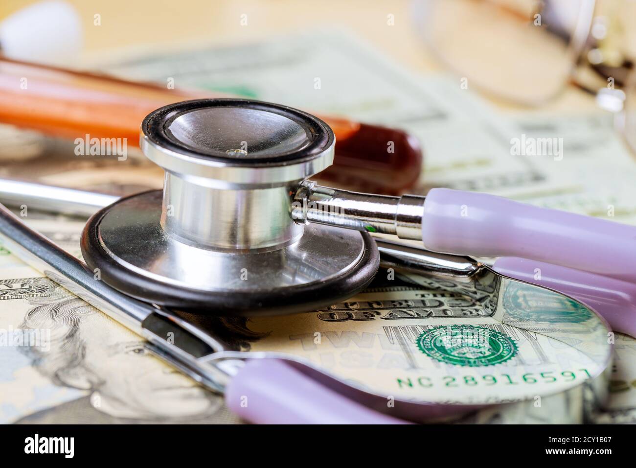 Medicine expenses healthcare medicine health insurance, stethoscope in the money dollars banknote,on blood test tubes Stock Photo