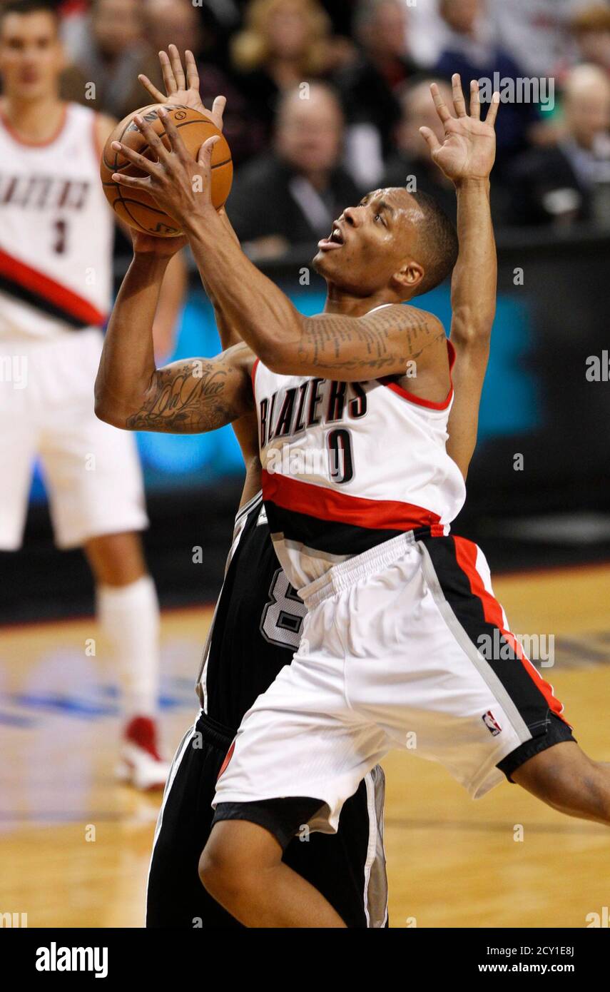 Portland Trail Blazers Point Guard Damian Lillard 0 Shoots As San Antonio Spurs Point Guard Patty Mills 8 Defends During Third Quarter Of Their Nba Basketball Game In Portland Oregon December 13