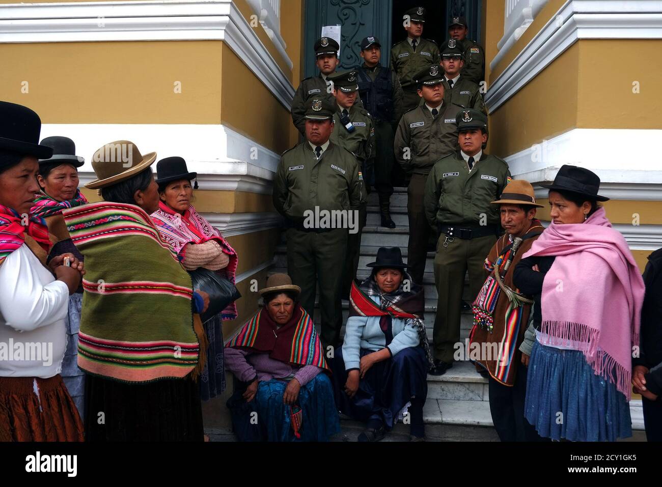 Members of Bolivia's CONAMAQ (National Council of Ayllus and Markas of Qullasuyu), a confederation to politically represent certain indigenous communities, sit outside the congress building as they keep vigil for their leaders who have been on a hunger strike for the last four days, in La Paz, October 7, 2013. The CONAMAQ are protesting against the results of the last census, which caused the geographical region they represent to lose congressional seats for the next legislative elections in 2014, according to local media. The hunger strikers called off their protest on Monday, when it became  Stock Photo
