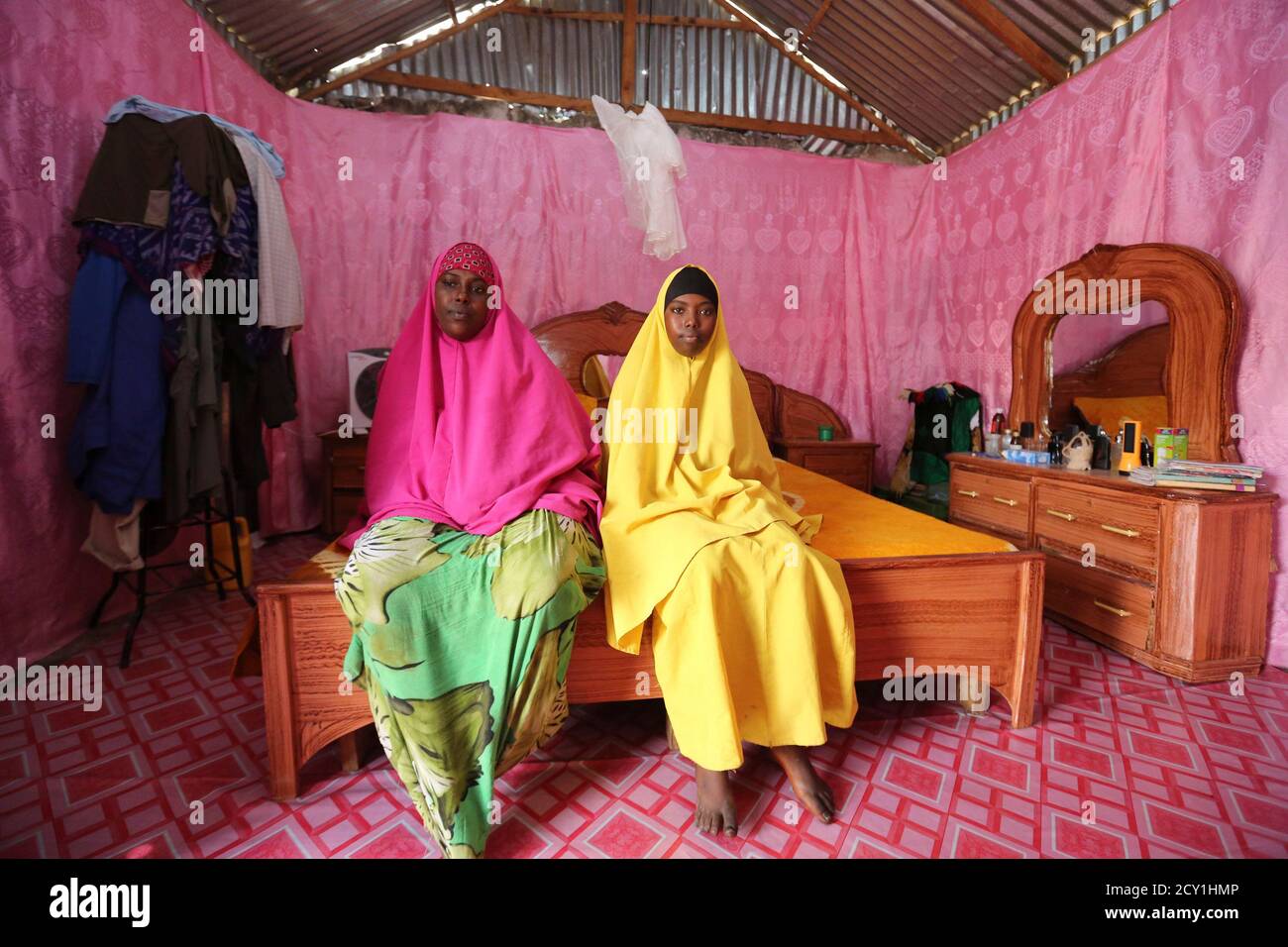 Saciido Sheik Yacquub, 34, poses for a picture with her daughter Faadumo Subeer Mohamed, 13, at their home in Hodan district IDP camp in Mogadishu February 11, 2014. Saciido, who runs a small business, wanted to be a business woman when she was a child. She studied until she was 20. She hopes that Faadumo will become a doctor. Faadumo will finish school in 2017 and hopes to be a doctor when she grows up. On March 8 activists around the globe celebrate International Women's Day, which dates back to the beginning of the 20th century and has been observed by the United Nations since 1975. The UN Stock Photo
