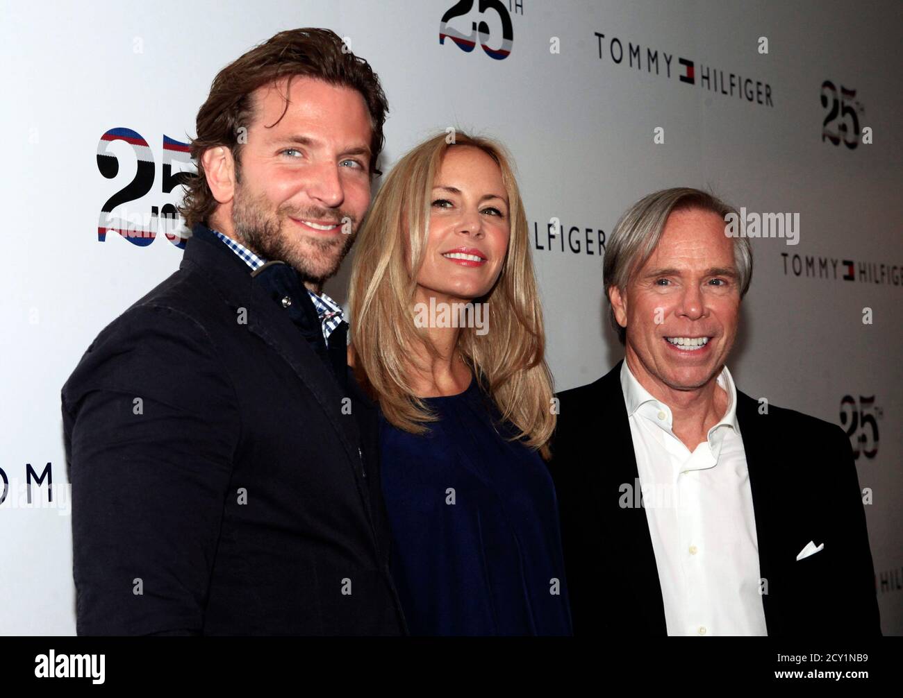 Actor Bradley Cooper, designer Tommy Hilfiger and Hilfiger's wife Dee  Ocleppo attend the Tommy Hilfiger Spring 2011 collection show during New  York Fashion Week September 12, 2010. REUTERS/Eric Thayer (UNITED STATES -