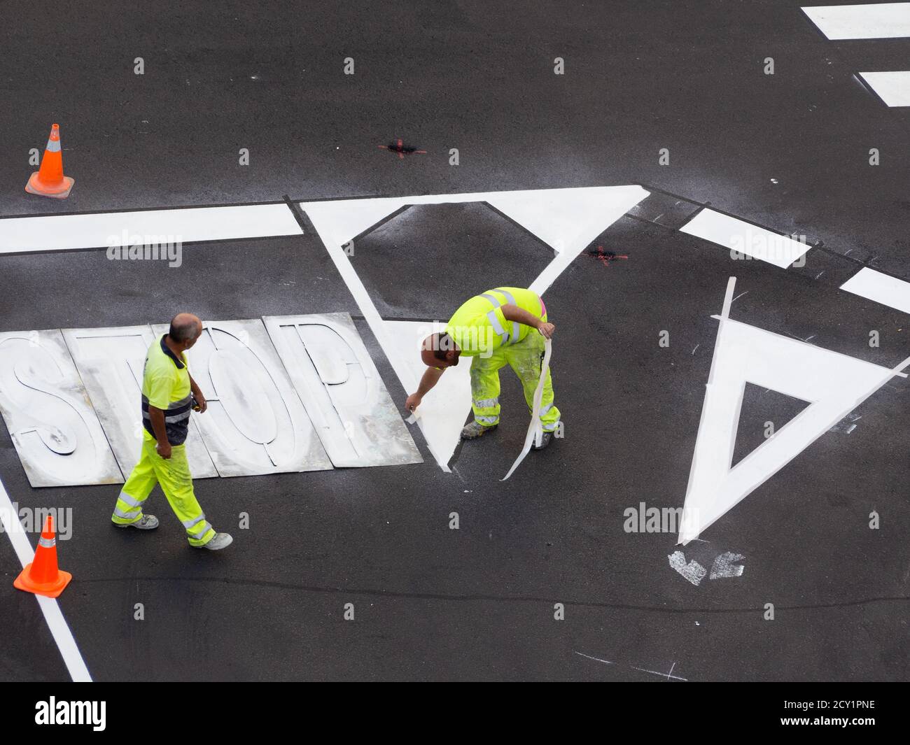 Workers paving and painting the streets Stock Photo - Alamy
