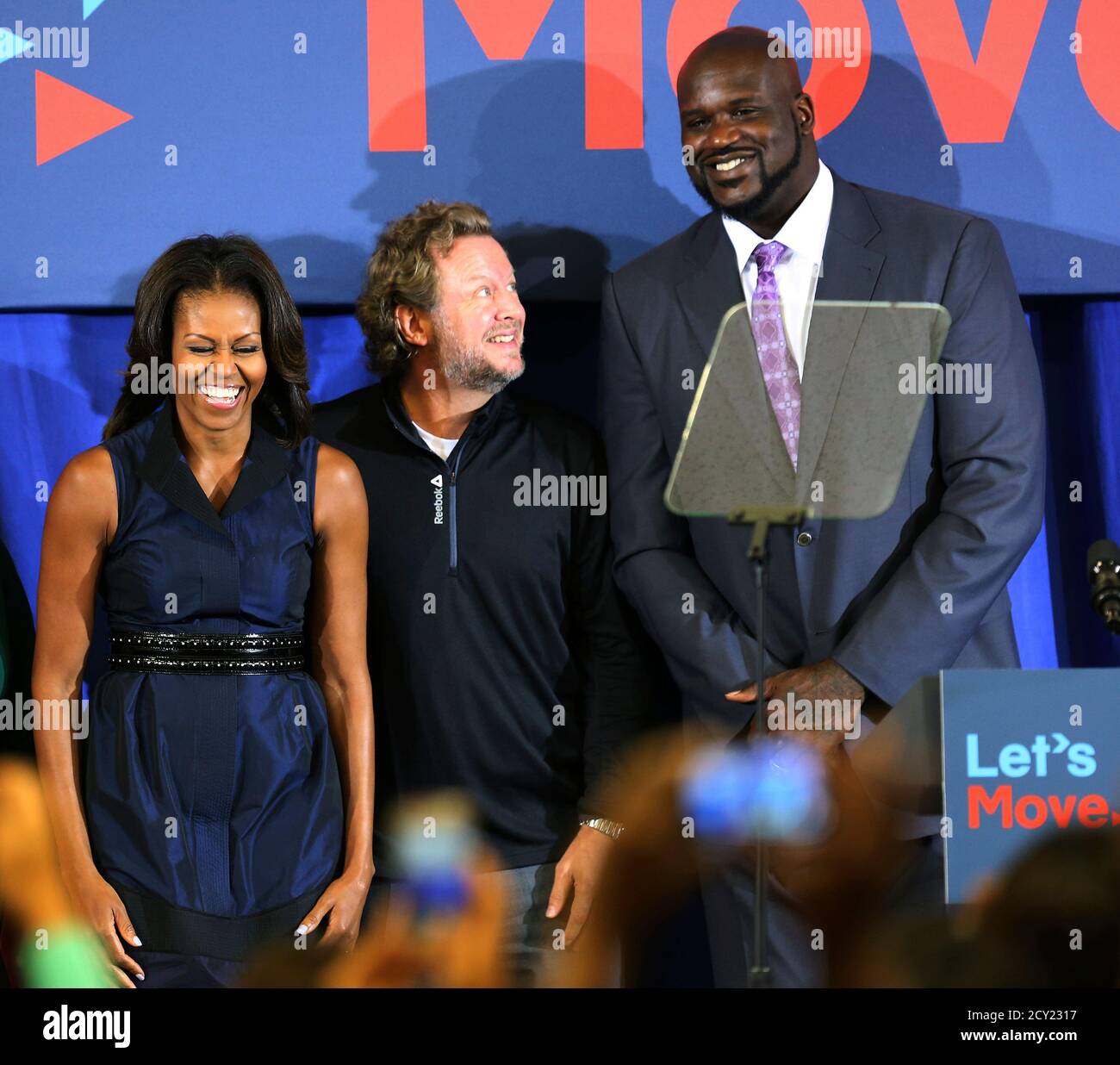 U.S. First Lady Michelle Obama (L-R), North America Reebok President Uli  Becker and former NBA star Shaquille O'Neal attend a back-to-school event  at Orr Elementary School in Washington September 6, 2013. REUTERS/Gary