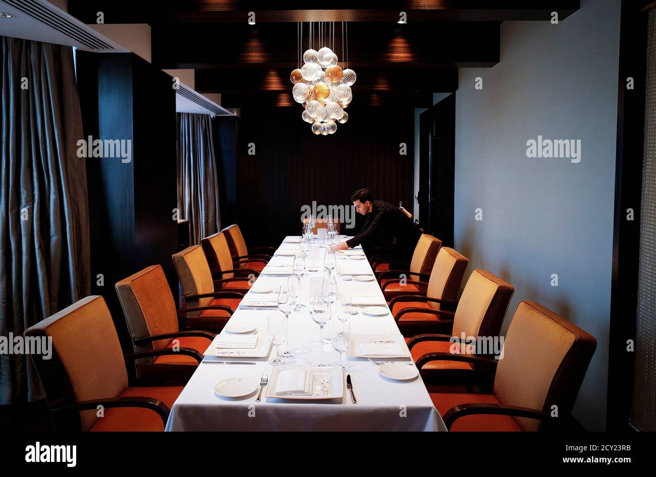 An Employee Of Le Cirque Signature Restaurant Prepares A Table Inside A Private Dining Room In Mumbai December 7 2013 The Branch Of New York S Venerable Le Cirque At The Leela Mumbai