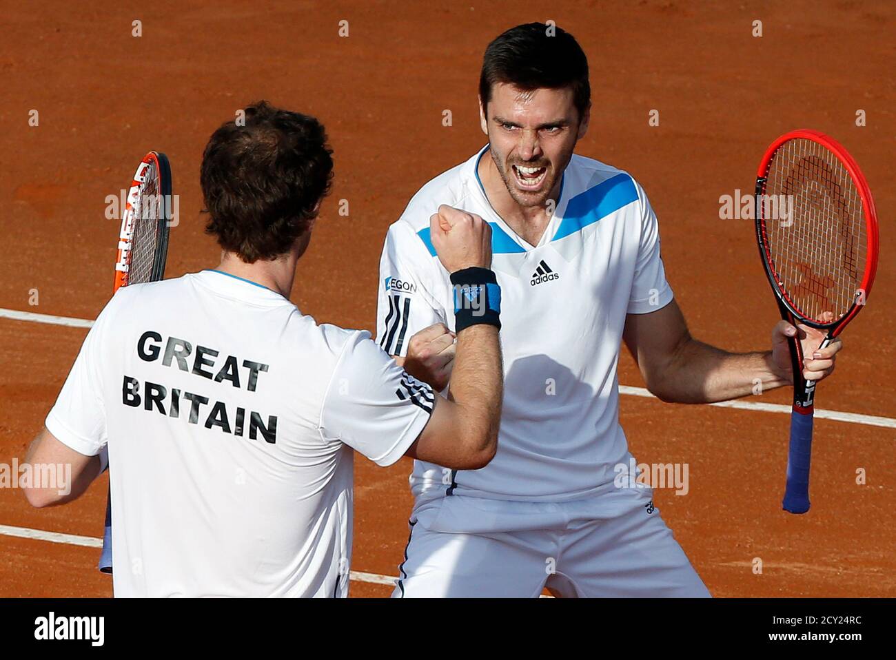 Britain's Andy Murray (L) and his teammate Colin Fleming celebrate after  winning their Davis Cup quarter-final doubles tennis match against Italy's  Fabio Fognini and Simone Bolelli in Naples April 5, 2014. REUTERS/Alessandro