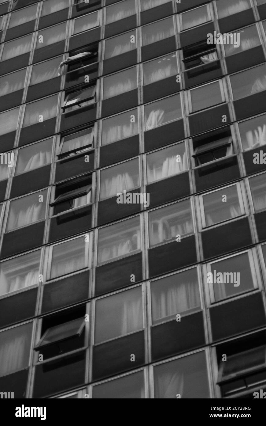 Vertical grayscale shot of a glass building facade Stock Photo - Alamy