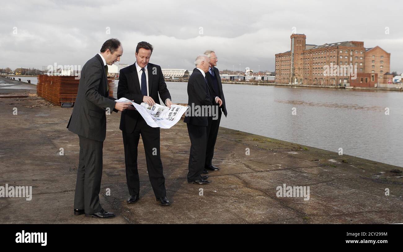 Britain's Prime Minister David Cameron (2nd L) tours the £4.5 billion (6.9 billion US dollars) Wirral Waters development on Merseyside with Richard Mawdsley (L) and Peter Nears of Peel Holdings and Lord Heseltine (R) in Wirral, northwest England January 6, 2011. Britain's path to a sustainable recovery will be tough but is within reach, Prime Minister David Cameron said on Thursday, seeking to shift focus to enterprise and away from his tough agenda of tax hikes and spending cuts. REUTERS/Peter Byrne/POOL  (BRITAIN - Tags: POLITICS BUSINESS) Stock Photo