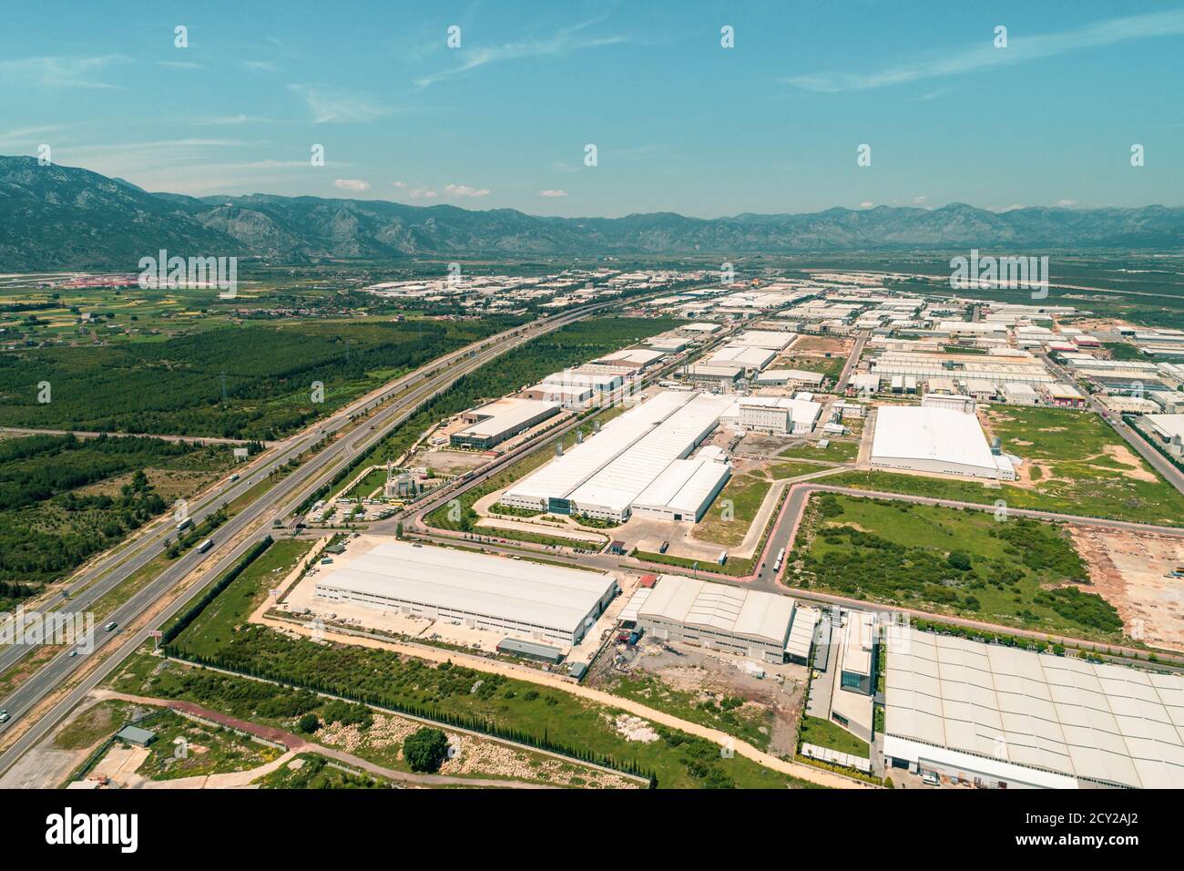 aerial top view photo of modern industrial zone settled by the highway ...