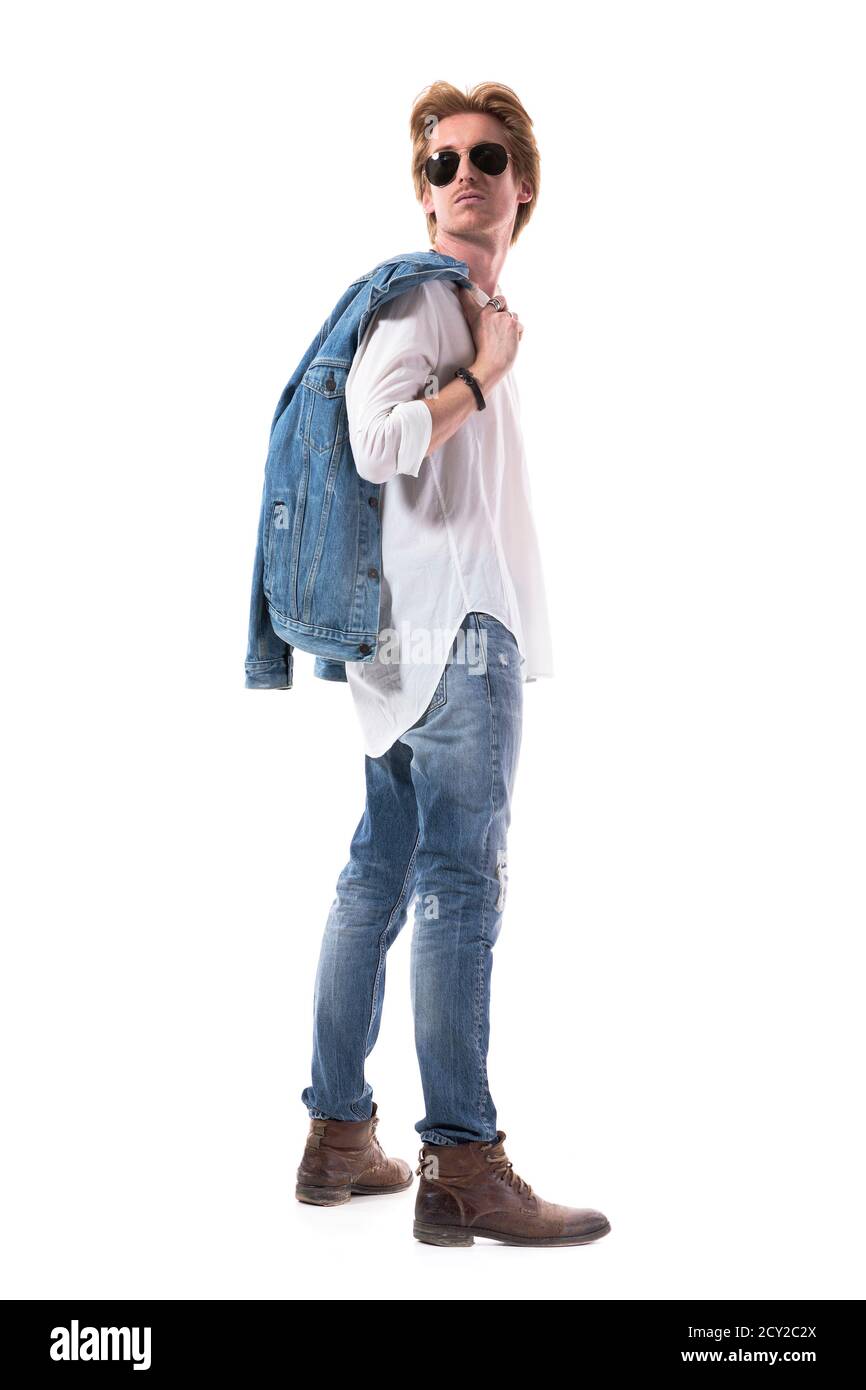 Side view of photogenic young man in jeans carrying jacket looking back over  shoulder. Full body isolated on white background Stock Photo - Alamy