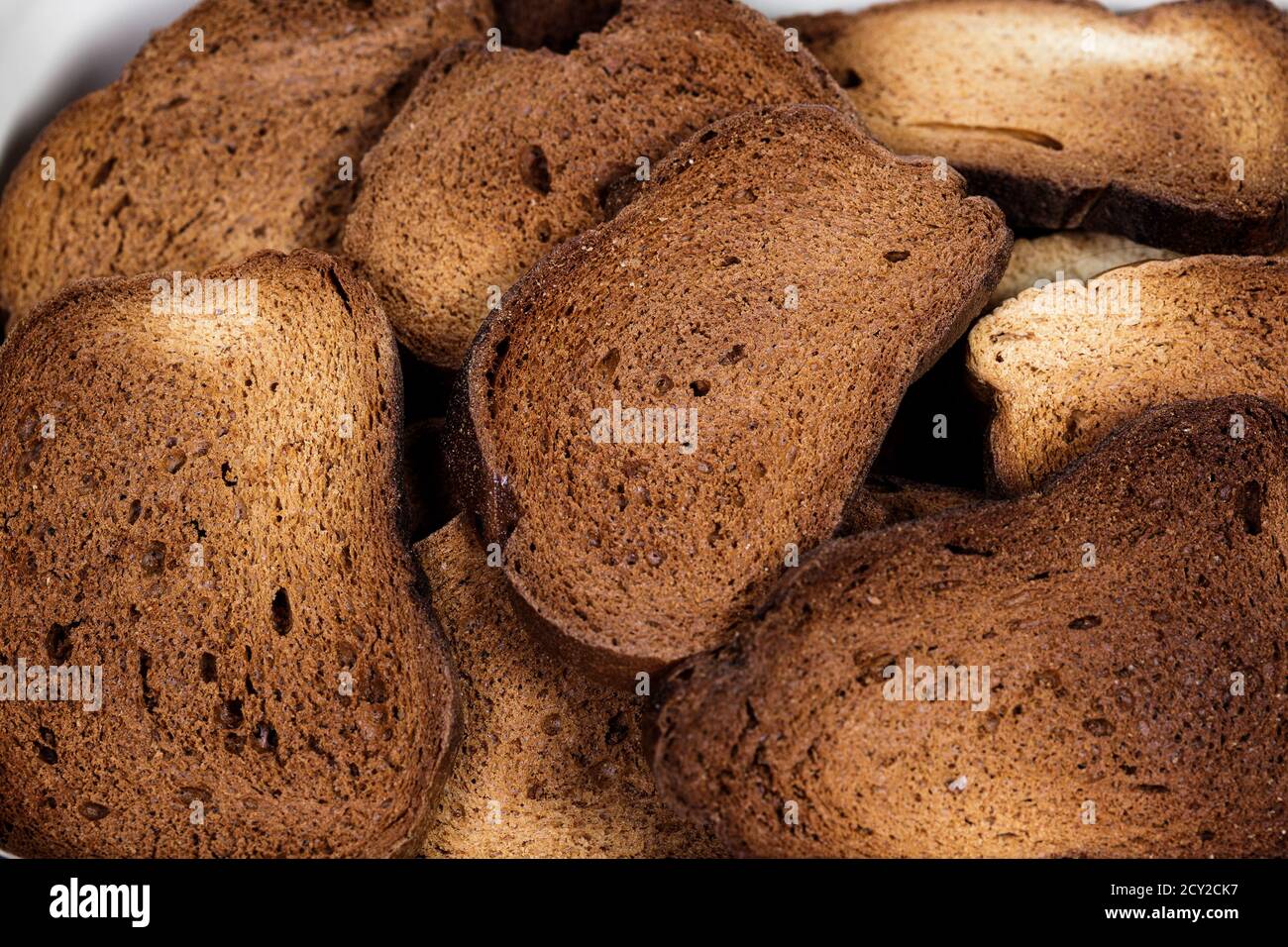 The texture of toasted pieces of bread. Croutons on a white background