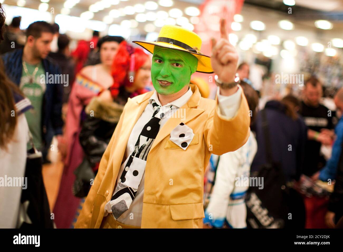 A cosplay enthusiast wearing the costume of the movie character "The Mask"  reacts at the Polymanga show in Lausanne, April 7, 2012. Polymanga is the  largest manga, anime, video games and pop