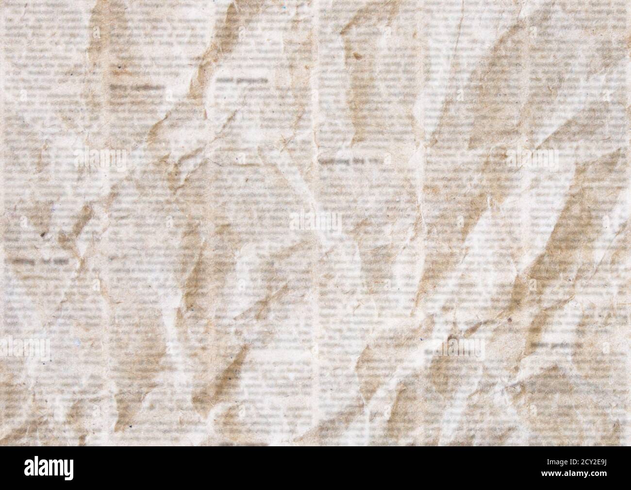 Old crumpled grunge newspaper paper texture background. Blurred vintage newspaper background. Crumpled paper textured page. Sepia color collage news p Stock Photo