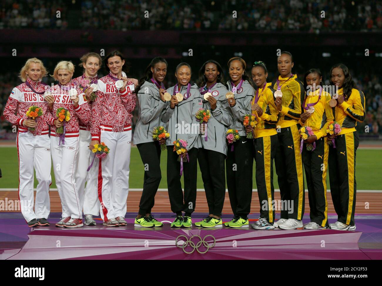 Gold Medal Winners Of The U S C Stand With Silver Medal Winners Russia L And Bronze Medal Winners Jamaica During The Women S 4x400m Relay Victory Ceremony At The London 2012 Olympic Games