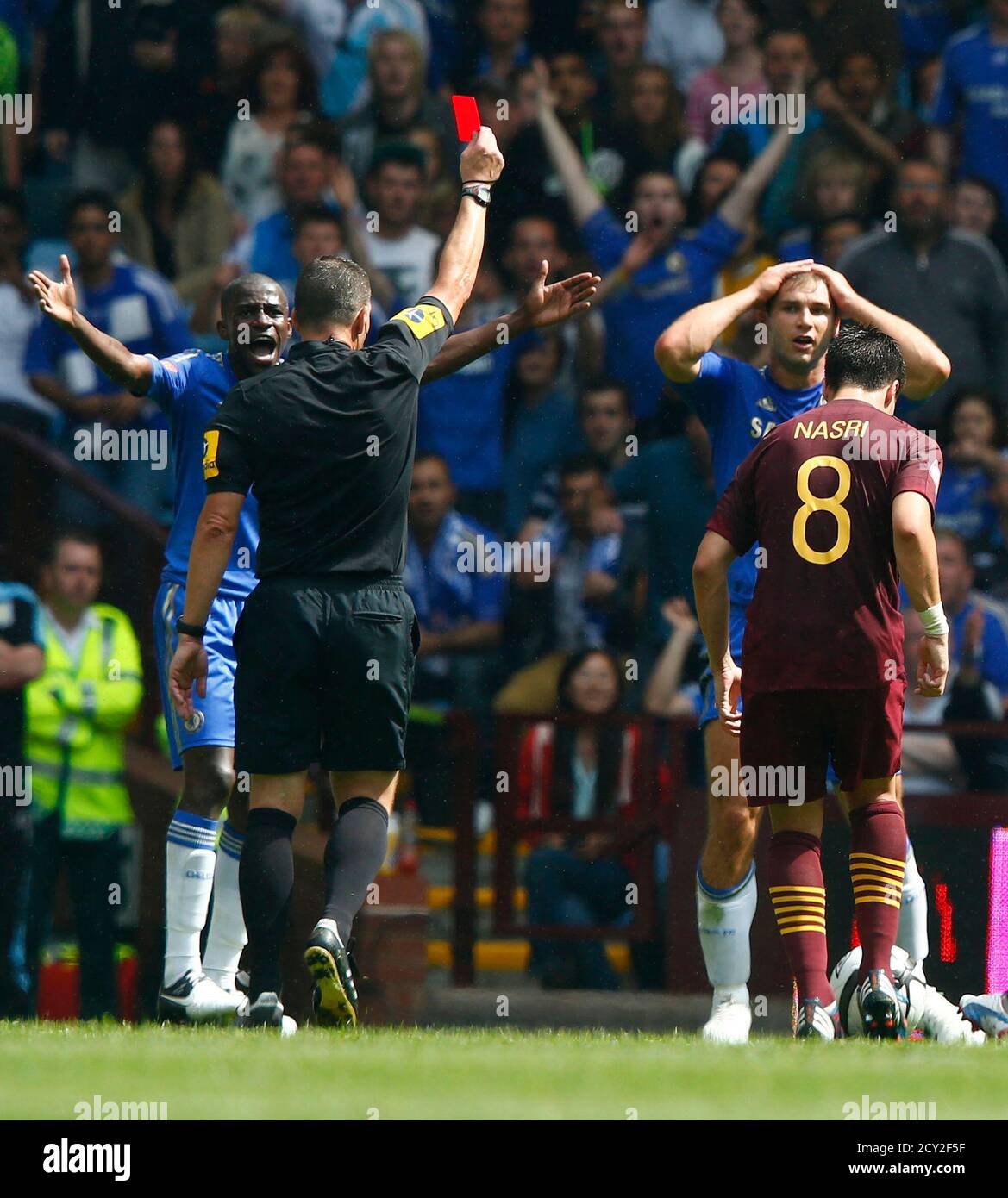 Chelsea's Branislav Ivanovic (2nd R) holds his head after being shown a red card by referee Kevin Friend during their Community Shield soccer match against Manchester City at Villa Park in Birmingham, central England August 12, 2012.    REUTERS/Eddie Keogh (BRITAIN - Tags: SPORT SOCCER) Stock Photo