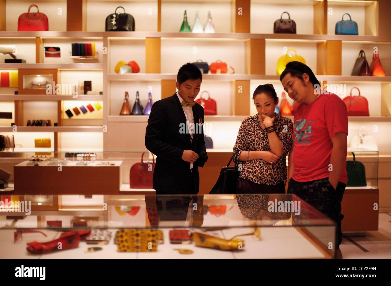 A couple shop at a Louis Vuitton store during Vogue's 4th Fashion's Night  Out: Shopping Night with Celebrities in downtown Shanghai September 7,  2012. Louis Vuitton is courting China's wealthy with one-of-a-kind