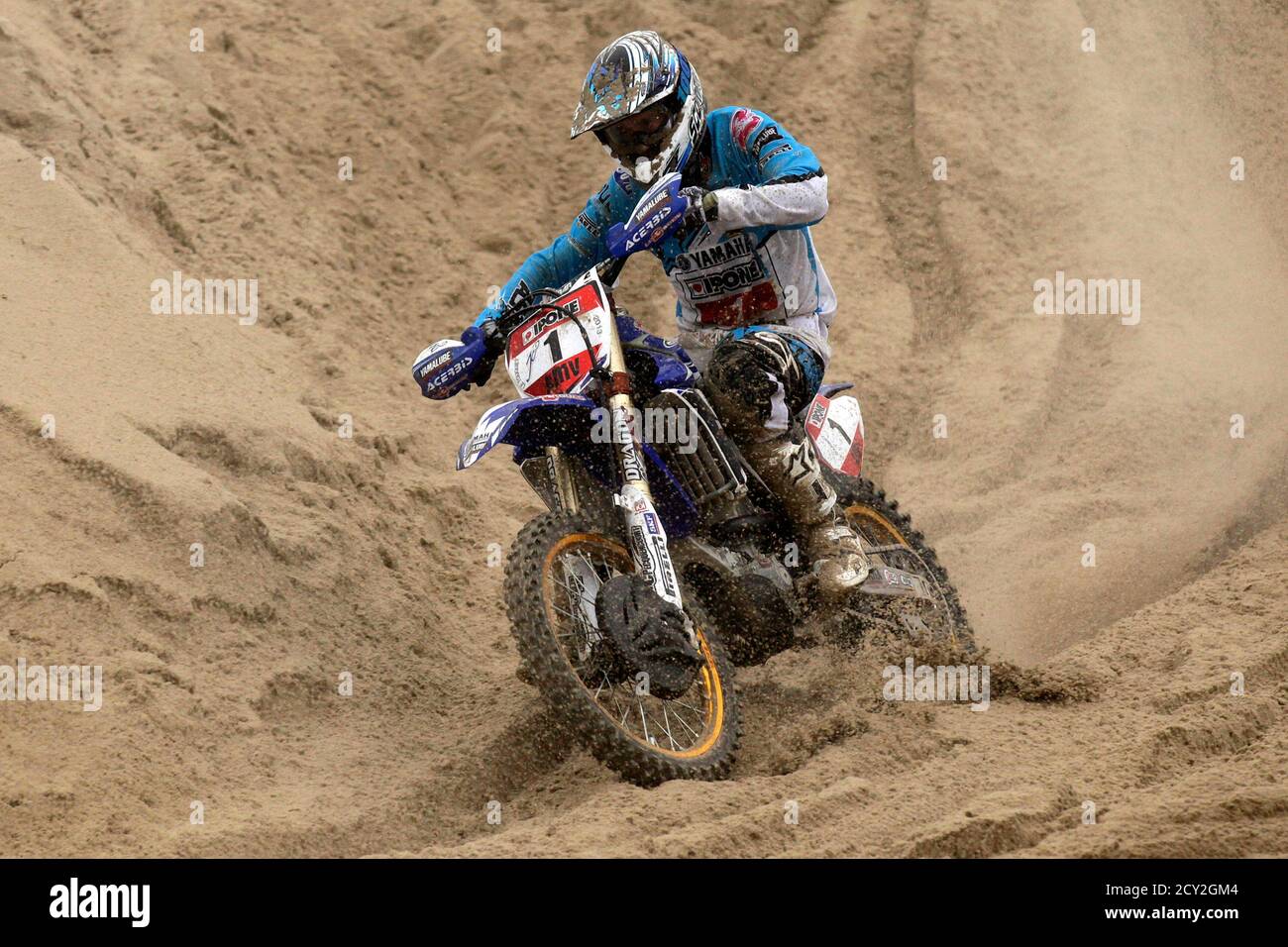 Jean Claude Mousse of France powers through the sand on his way to win the  "Enduropale" motorcycle endurance race on the beach of Le Touquet February  3, 2013. About 1,000 motorbike and