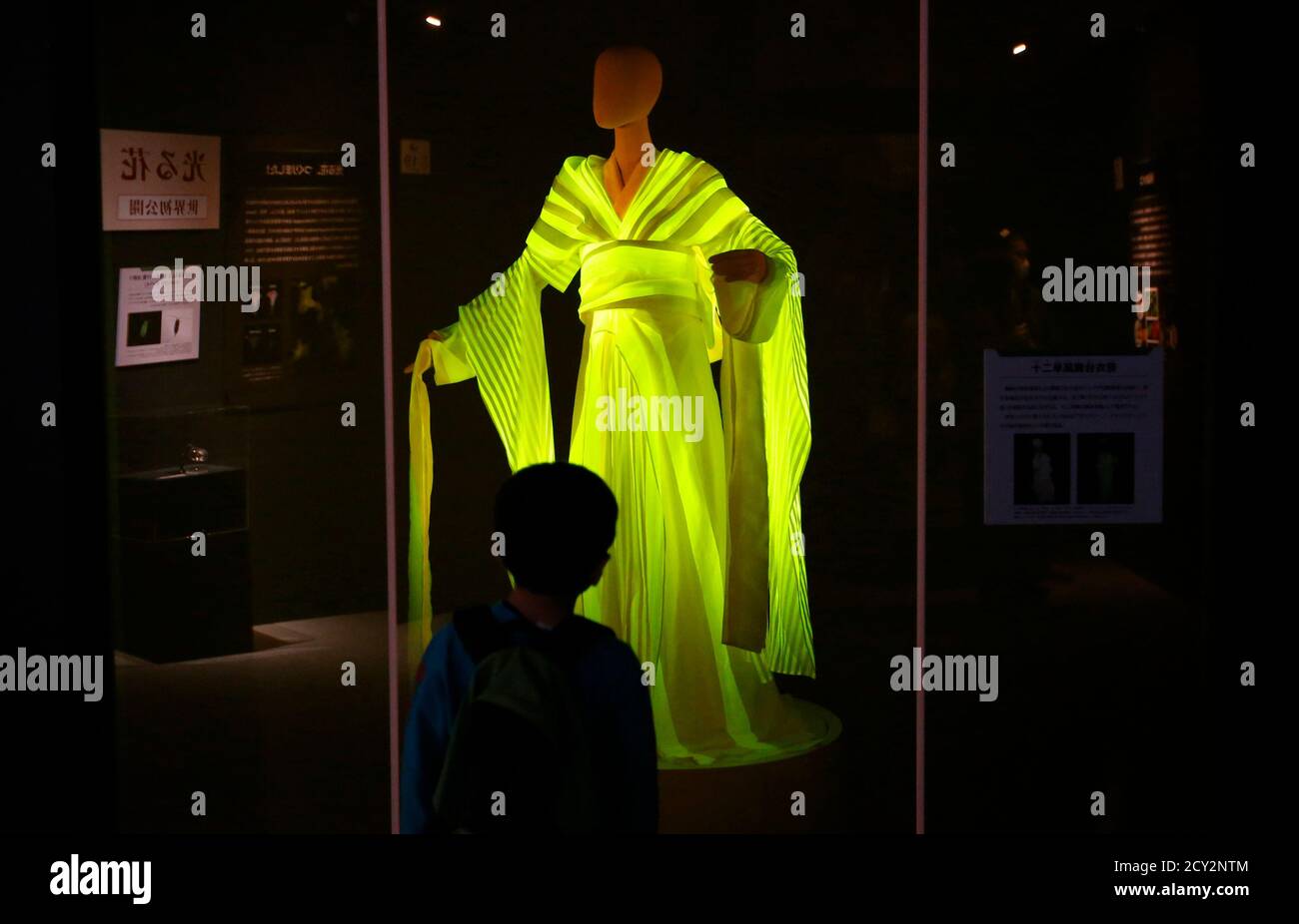 A Boy Looks At A Kimono Made From Silkworm Cocoons Which Glow Yellow When Exposed To Blue Leds At The Hikari The Wonder Of Light Exhibition At The National Museum Of Nature A Boy Looks At A Kimono Made From Silkworm Cocoons Which Glow Yellow When Exposed To Blue Leds At The Hikari The Wonder Of Light Exhibition At The National Museum Of Nature