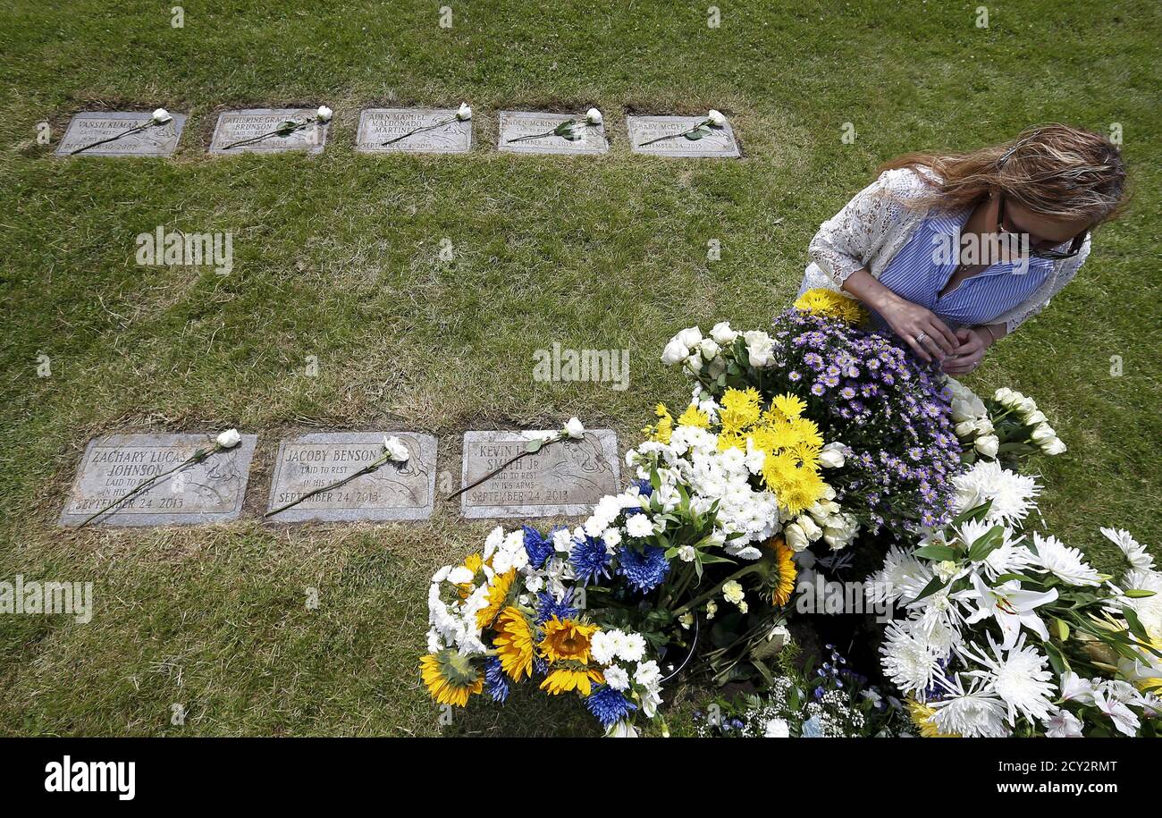 Boy 3 Years With Flowers At A Grave On A Cemetery Stock Photo Alamy