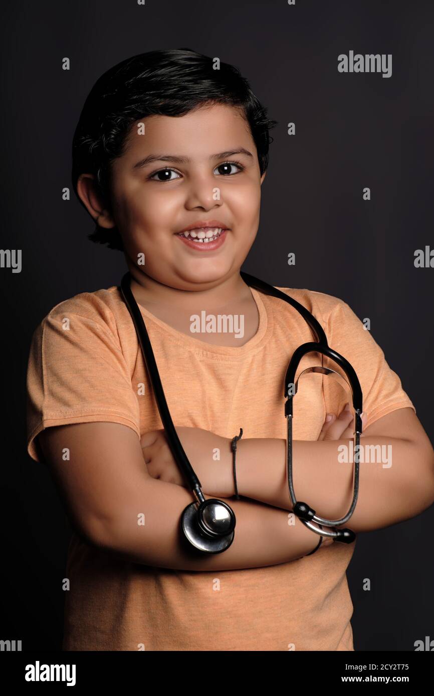 A little cute smiling girl as a doctor with stethoscope Stock Photo