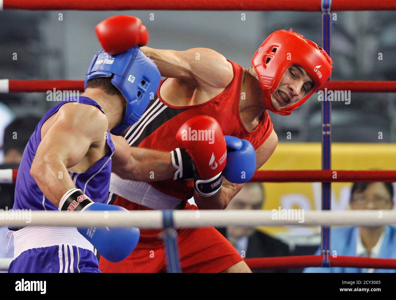Mohamed Hikal of Egypt (red) fights against Hzam Ahmad Nabah of Qatar  during their men's 75kg-middle quarterfinals boxing match at the Arab Games  in Doha December 14, 2011. REUTERS/Suhaib Salem (QATAR -