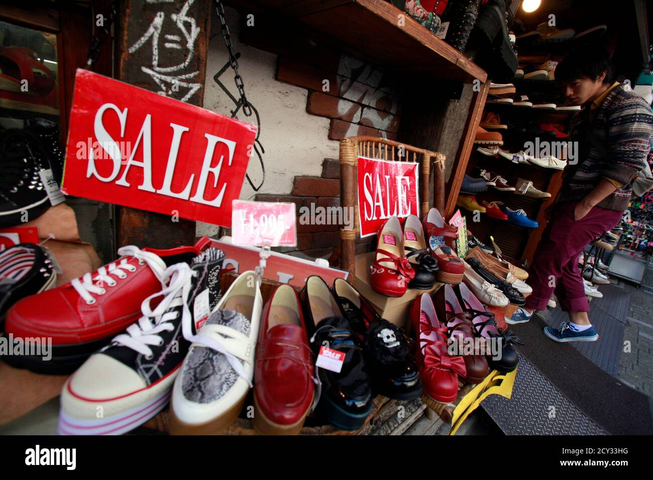 Shoes on sale are displayed outside a store in Tokyo's Harajuku shopping  district October 26, 2012. Japan remains mired in deflation, price data  showed on Friday, piling pressure on the central bank