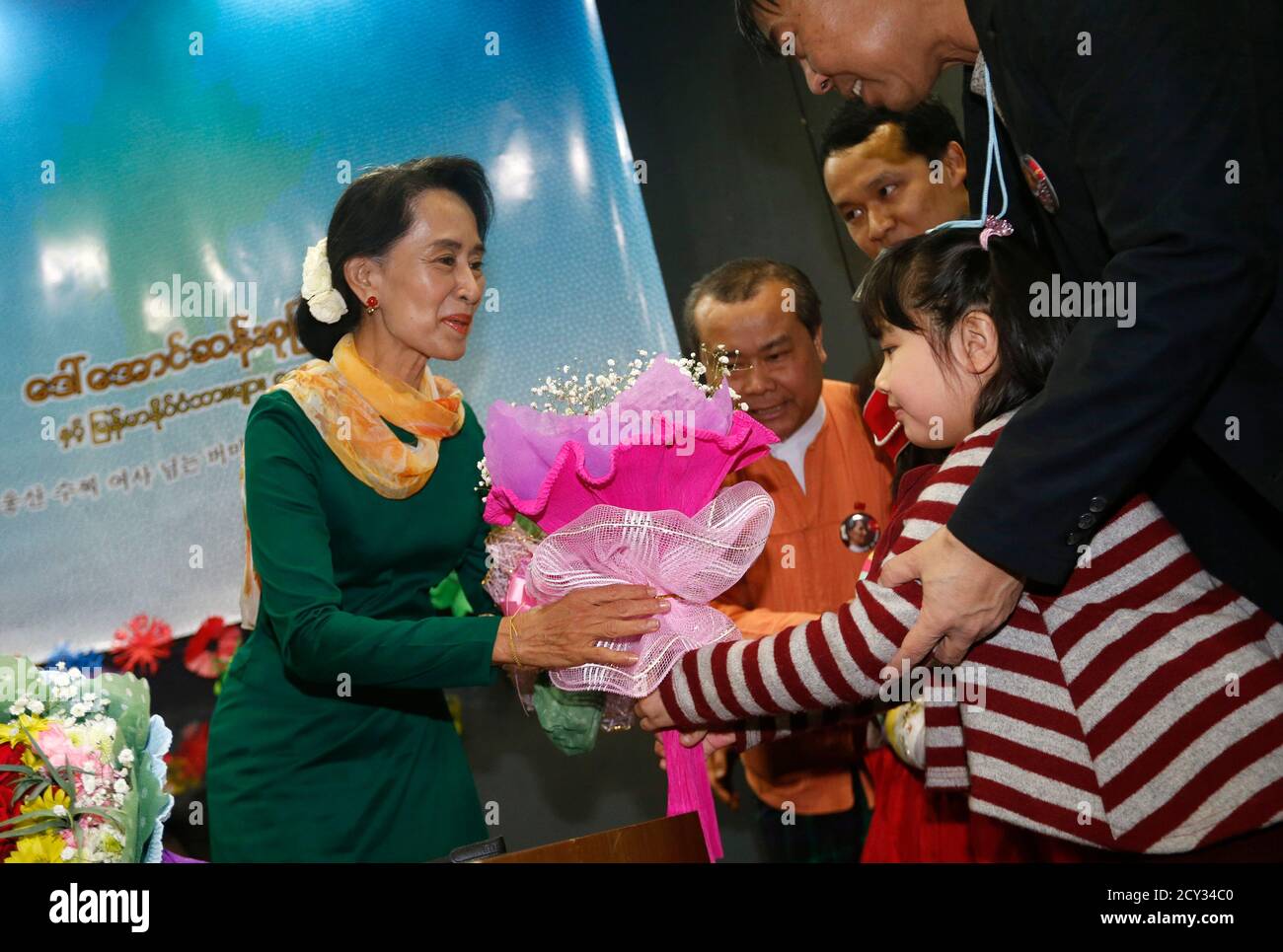 A Child From Myanmar Presents A Bouquet Of Flowers To Visiting Myanmar Opposition Leader Aung San