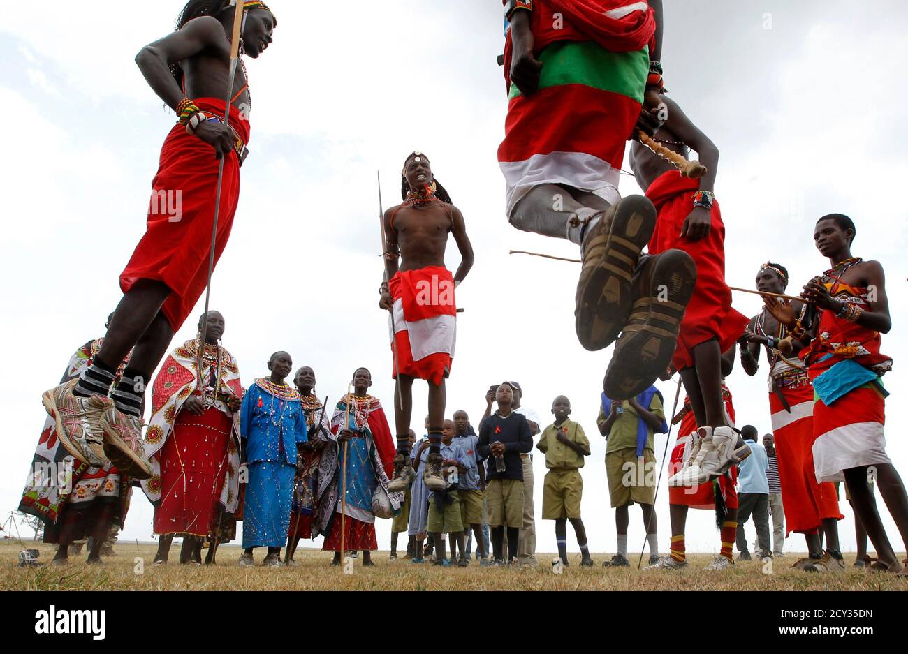 Members of the Maasai Cricket Warriors sing and jump to their traditional rhythm after their T20 cricket match against the Ambassadors of Cricket from India in the Ol Pejeta conservancy in Laikipia national park, June 6, 2013. The Maasai Cricket Warriors are role models in their communities where they actively campaign against retrogressive and harmful cultural practices, such as female genital mutilation and early childhood marriages, while fighting to eradicate discrimination against women in Maasailand. Through cricket, they hope to promote healthier lifestyles and to also spread awareness  Stock Photo