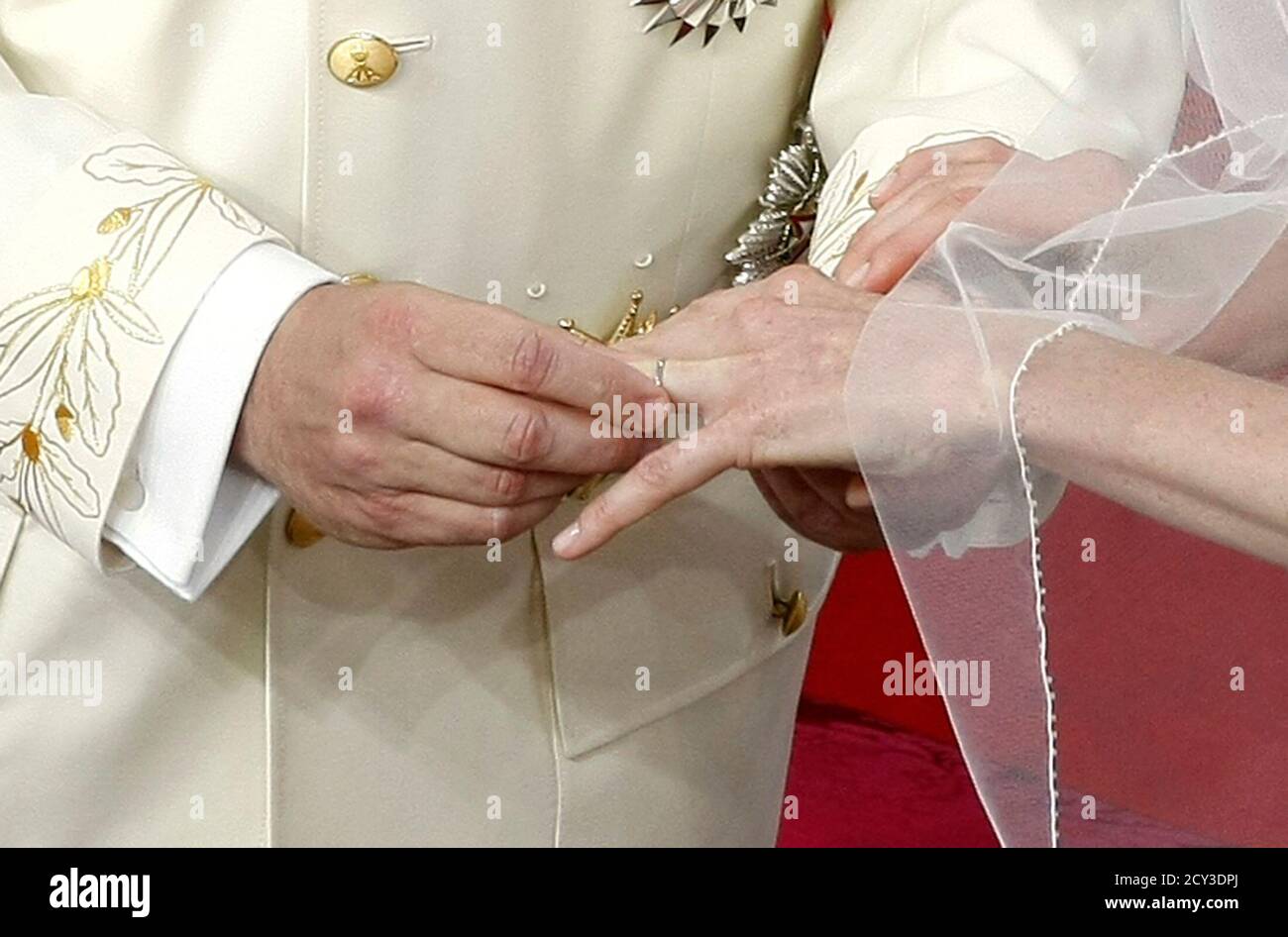 Prince Albert II of Monaco puts the wedding ring on the finger of his bride Princess  Charlene during their religious wedding ceremony at the Palace in Monaco  July 2, 2011. REUTERS/Lionel Cironneau/Pool (