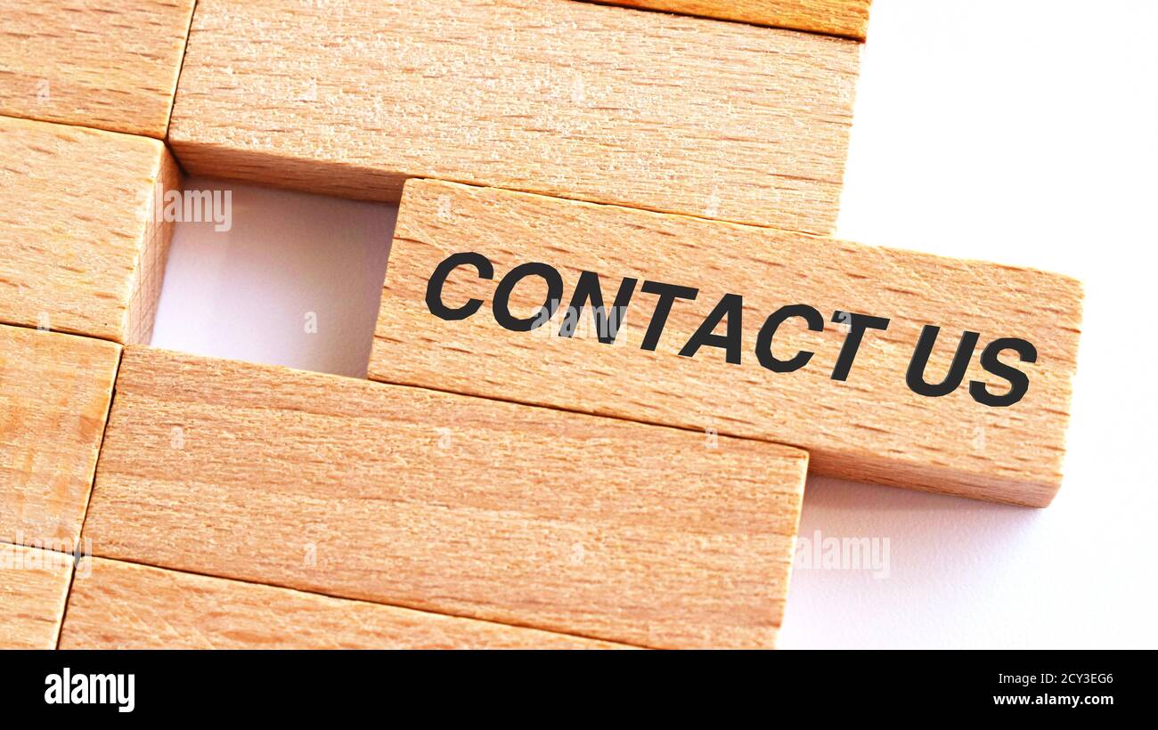 CONTACT US written on wood blocks. Business concept.A piece of wood with text CONTACT US Stock Photo