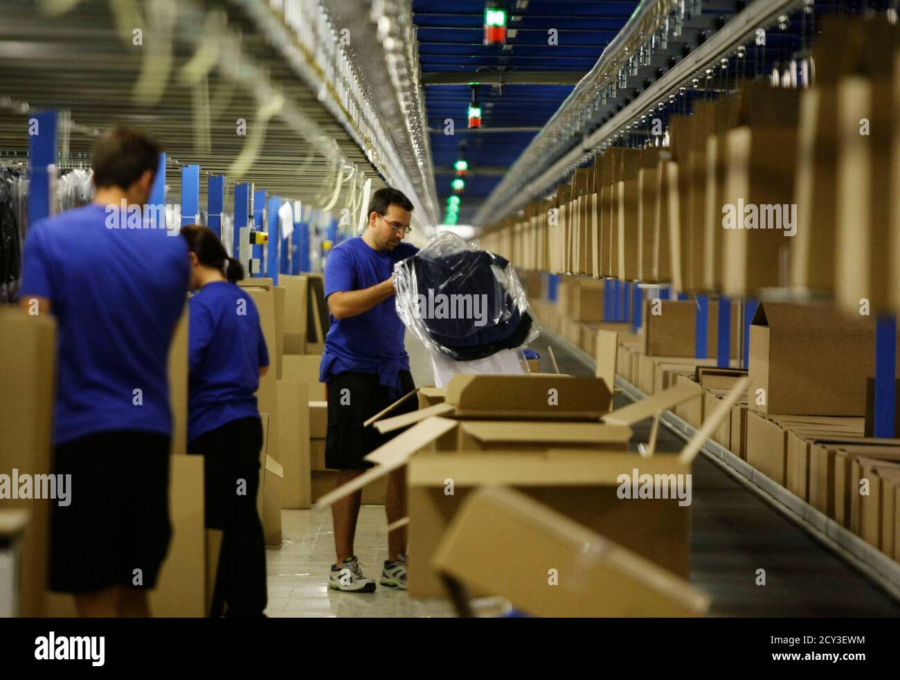 Men work at the Zara factory at the headquarters of Inditex group in  Arteixo, northern Spain, July 15, 2011. The green, rainy region of Galicia  in northwest Spain is best-known as the