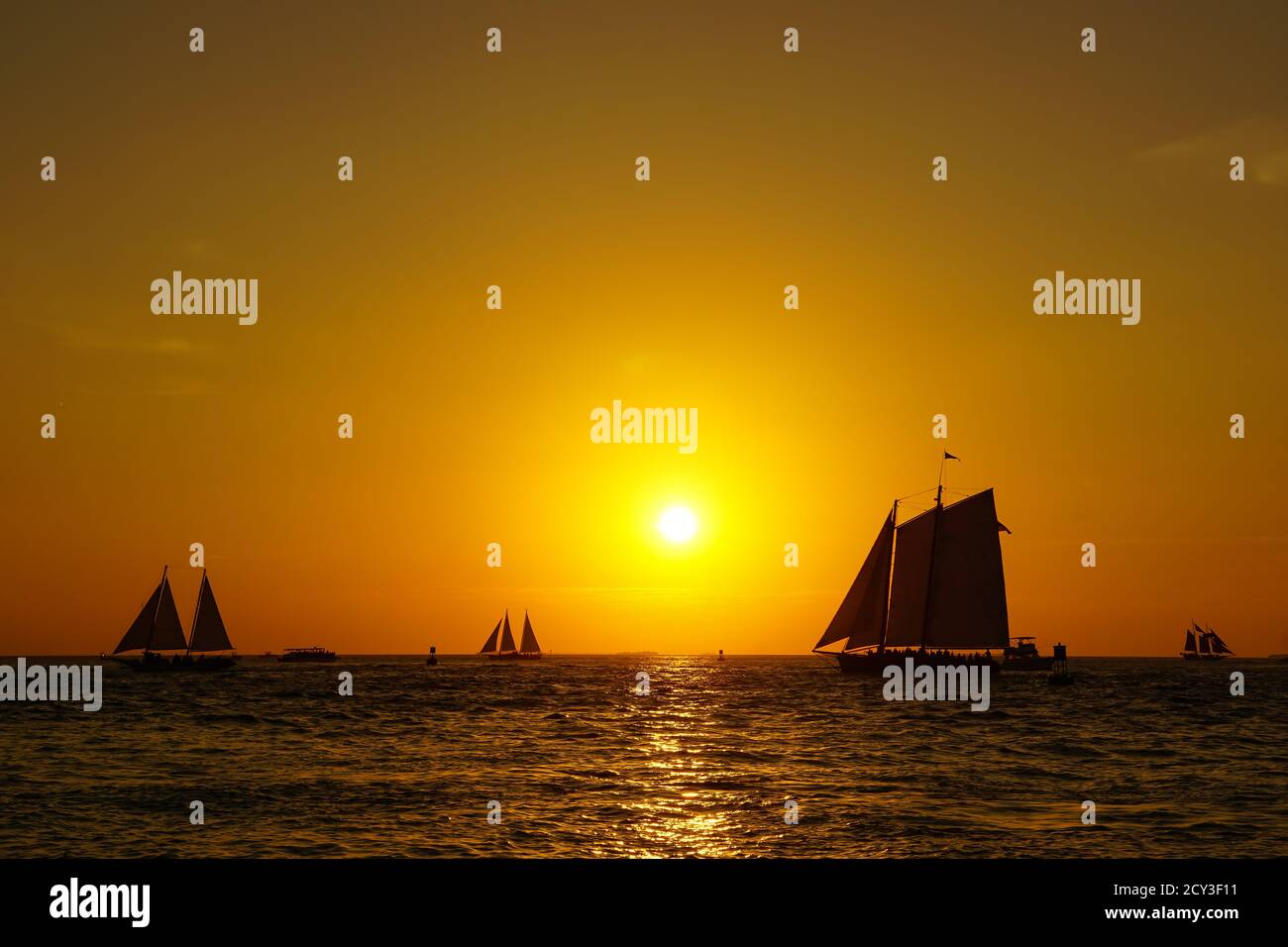 Key West sunset with multiple sailboats Stock Photo
