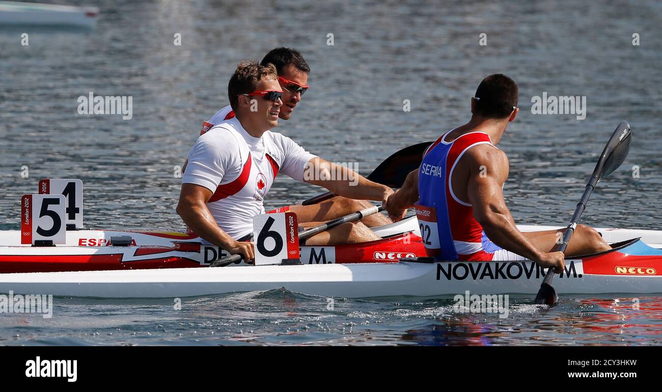 Canada's Mark de Jonge (C), Serbia's Marko Novakovic (R) and Spain's Saul  Craviotto Rivero congratulate each other after competing in the men's kayak  single (K1) 200m semifinal at the Eton Dorney during