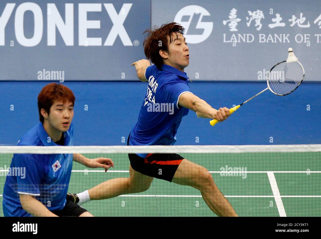 South Korea's Kim Sa Rang (R) hits a shot as Kim Ki Jung looks on against  Japan's Kenichi Hayakawa and Hiroyuki Endo during their mens' doubles  semi-final match at the Badminton Asia