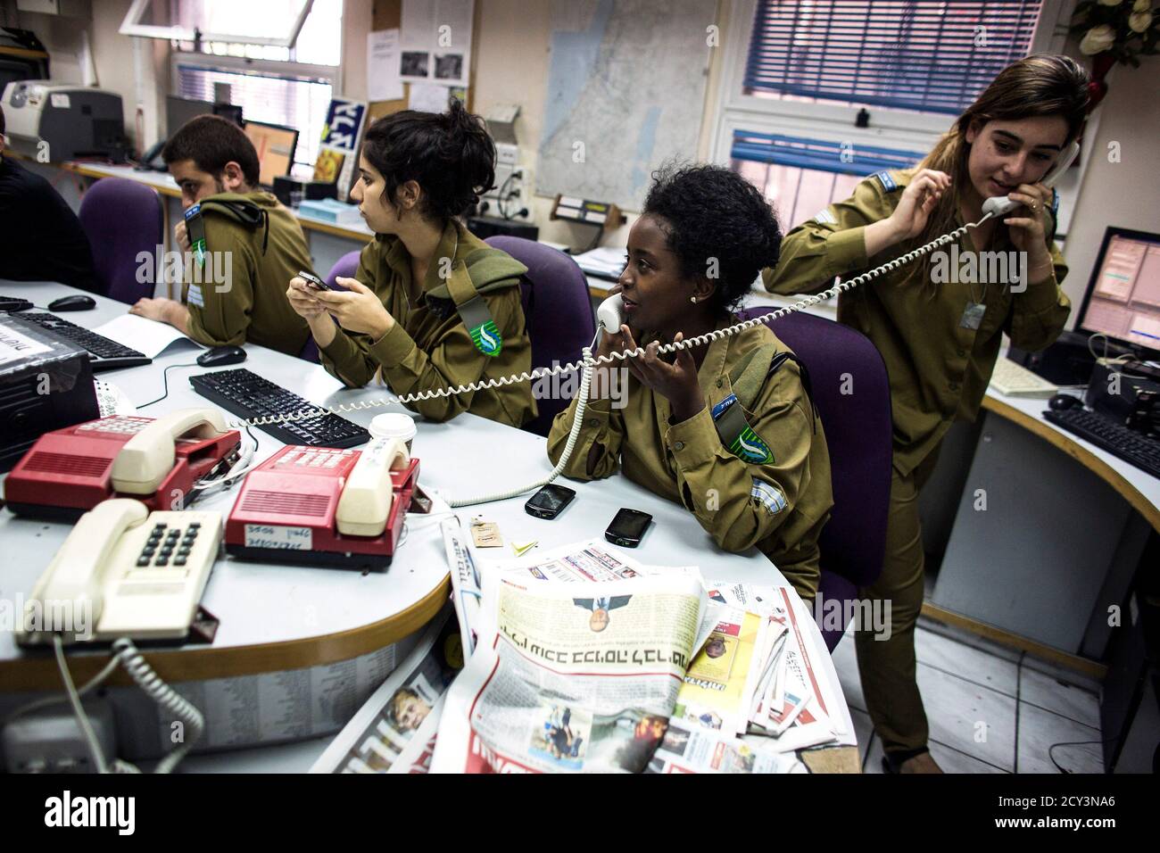 Israeli soldiers from Galei Tzahal, the Israeli army radio station, work in  the newsroom at the station's studios in Jaffa, south of central Tel Aviv  November 10, 2013. The Israeli military operates