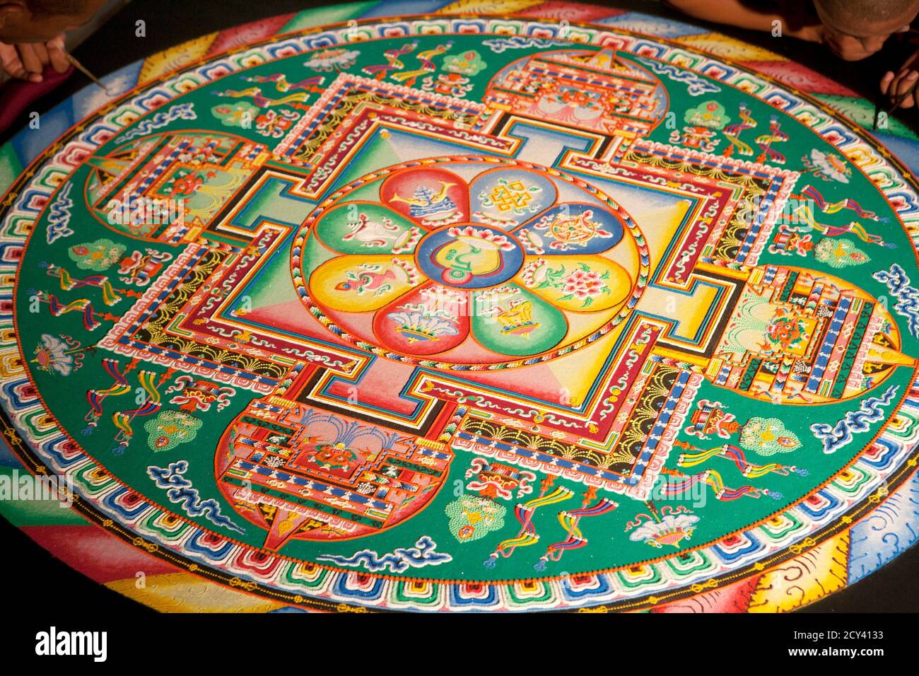 Tibetan monks work on a sand mandala during the First Tibetan Cultural Maya meeting in the Riviera Maya at Playa del Carmen September 11, 2011. The inaugural meeting aims to encourage the exchange of knowledge between these two ancient cultures and to share values related to the preservation of life and respect for nature. REUTERS/Victor Ruiz Garcia (MEXICO - Tags: RELIGION) Stock Photo