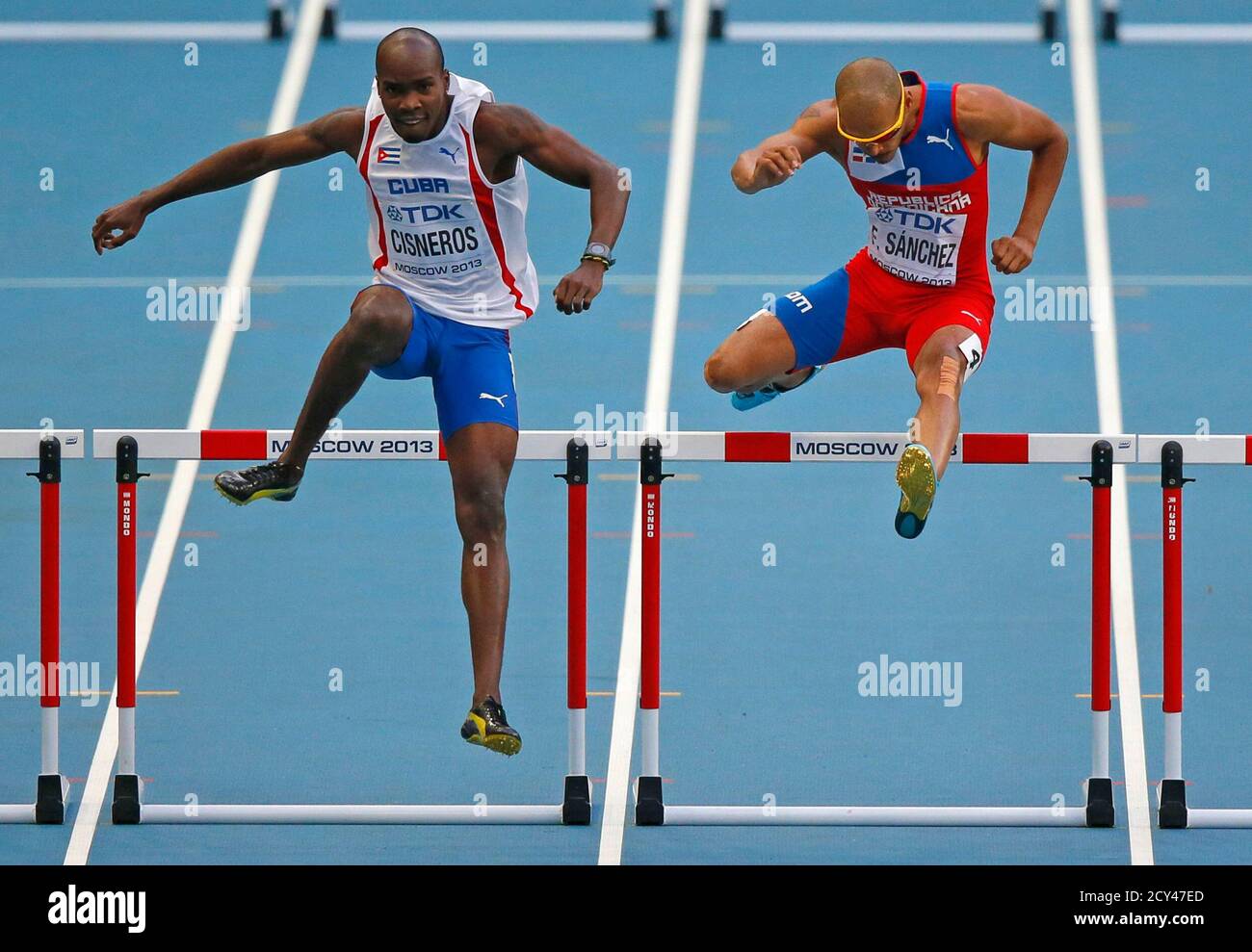 Omar Cisneros Of Cuba L And Felix Sanchez Of The Dominican Republic R Race In Their Men S 400 Metres Hurdles Semi Final During The Iaaf World Athletics Championships At The Luzhniki Stadium In